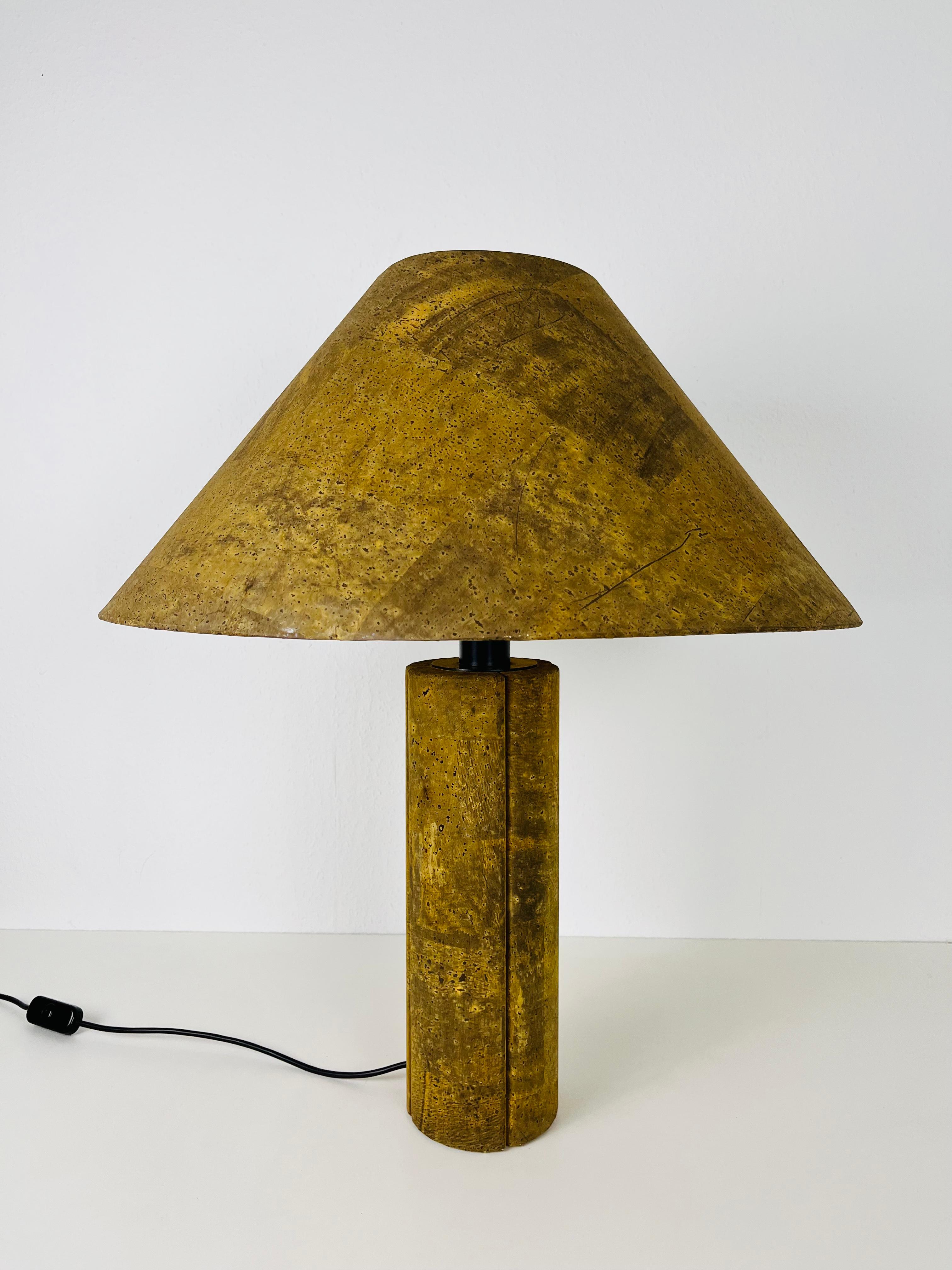 Iconic table lamp by Ingo Maurer made in the 1960s. The lighting is made of cork. The base has a wonderful cylinder shape.

The light requires one E27 (US E26) light bulb. Works with both 120/220V. Good vintage condition.

Free worldwide express