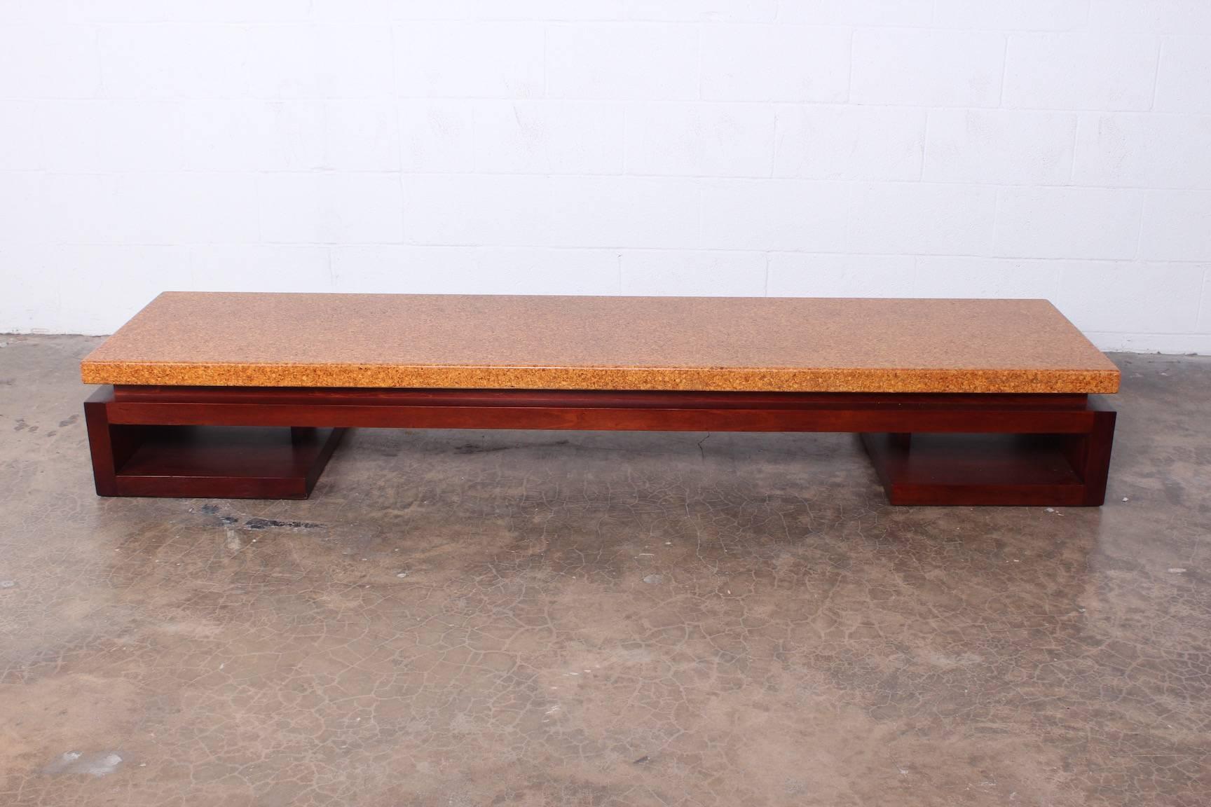 A cork top bench with mahogany base. Designed by Paul Frankl for Johnson furniture.