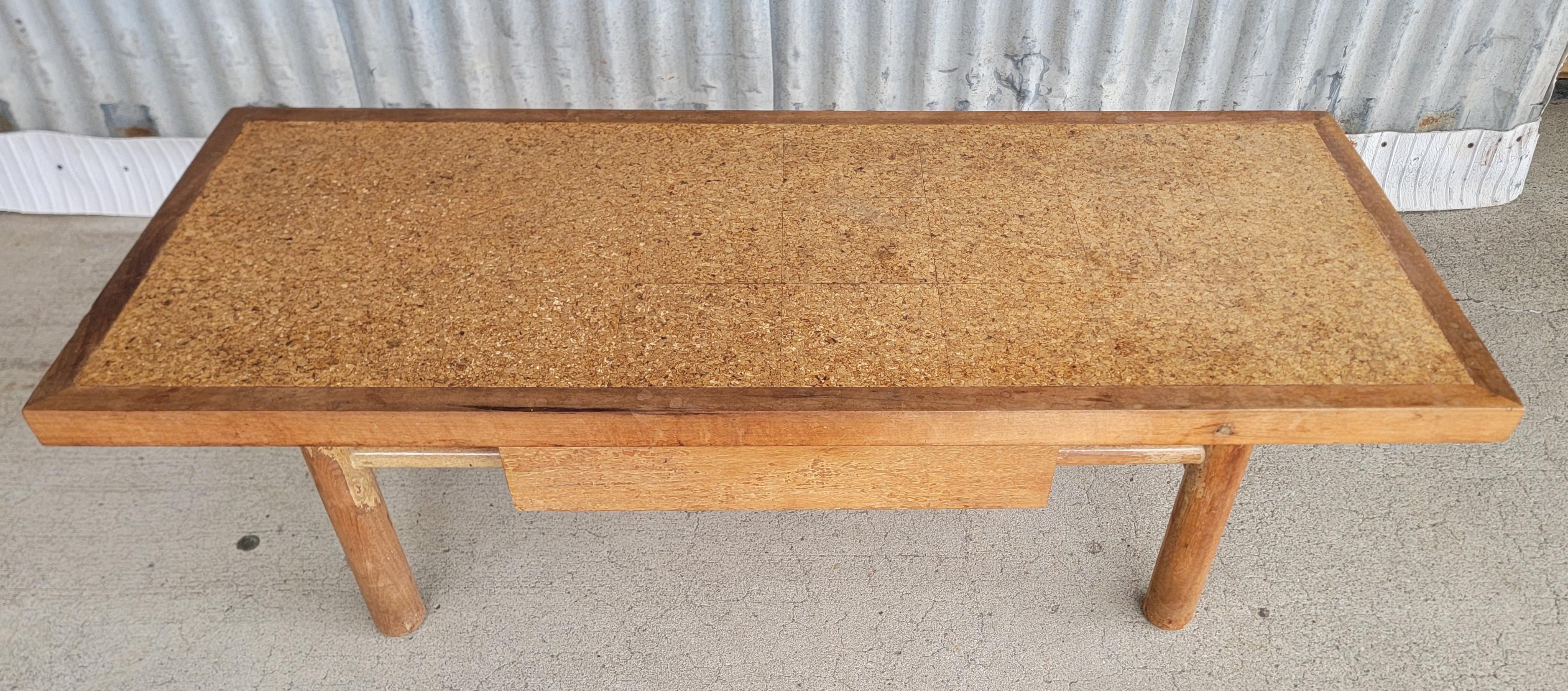 Unique cork top coffee table by American of Martinsville. Circa. 1950's. Designed in the style of Robsjohn-Gibbings. Bleached mahogany with a tile cork top surface. Single storage drawer in center. Original finish is mottled and has discoloration 