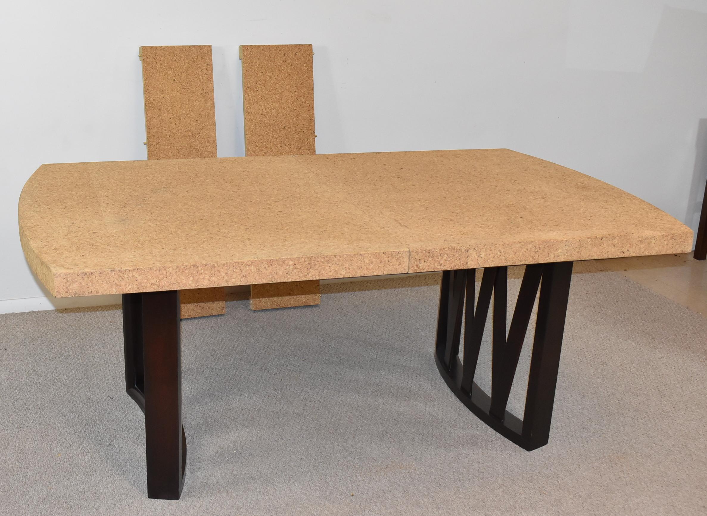 This cork top dining table was designed by Paul Frankl for Johnson Furniture Company. The top is natural cork with curved walnut support legs. The legs have an ebonized finish with decorative crisscross slats. The table is 72