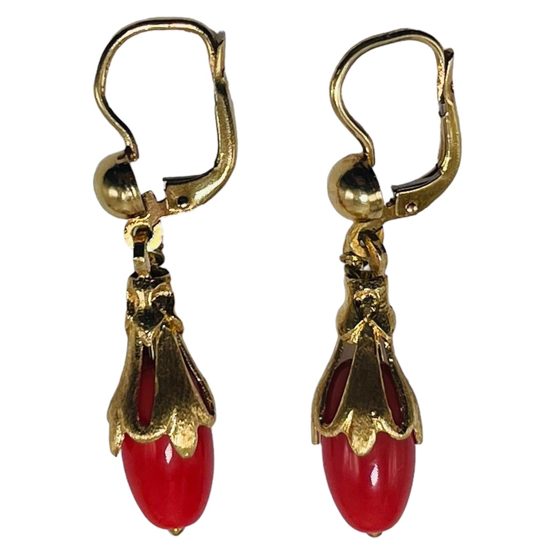 This is a Corletto Pair of 18K yellow gold Red Coral Drops Earrings. The coral is shaped as long tear drops mounted in 18K yellow gold garland of leaves with pression back. Both earrings are hallmarked Corletto 18K Italy.
