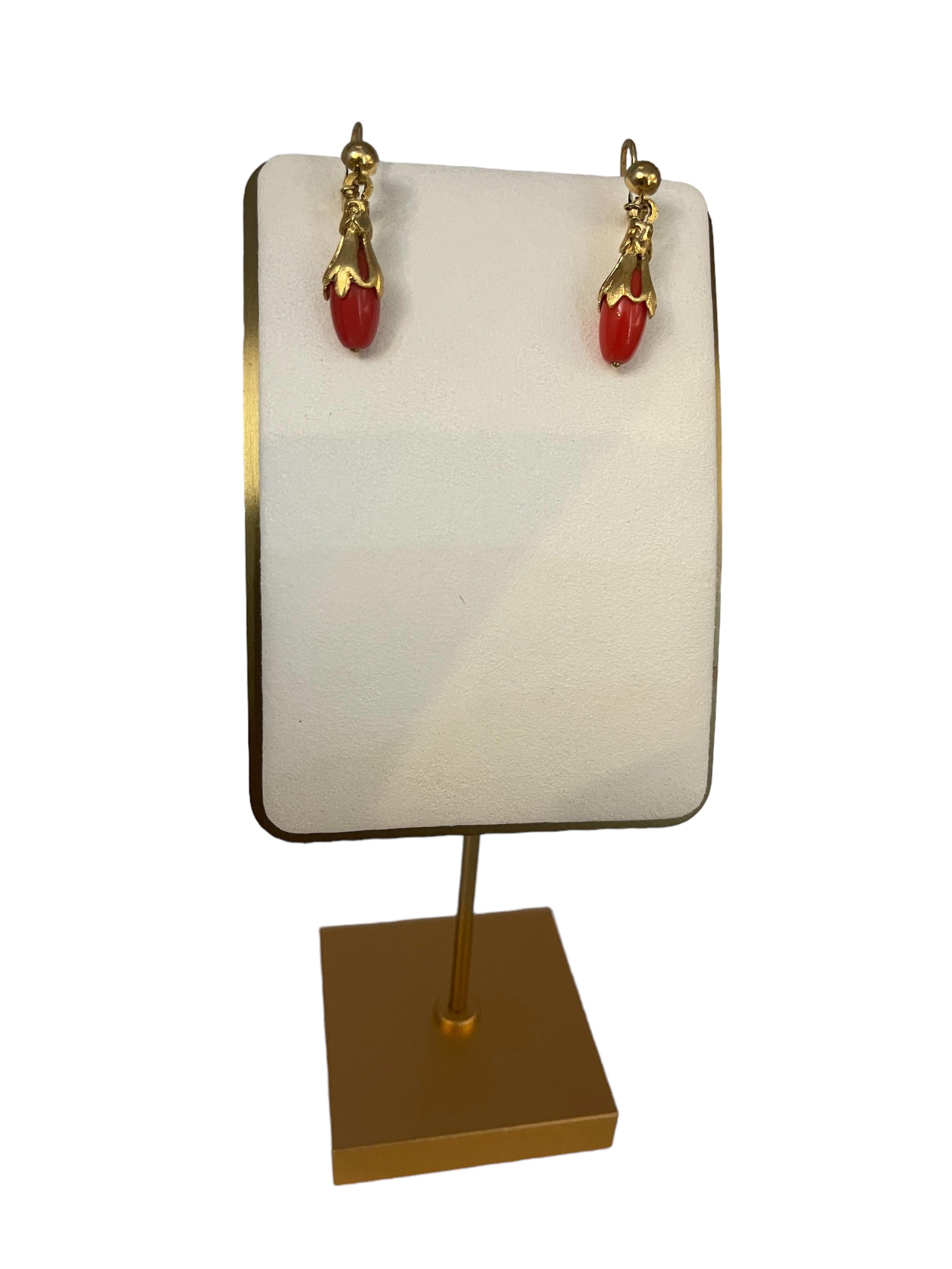 This is a Corletto Pair of 18K yellow gold Red Coral Drops Earrings. The coral is shaped as long tear drops mounted in 18K yellow gold garland of leaves with pression back. Both earrings are hallmarked Corletto 18K Italy.