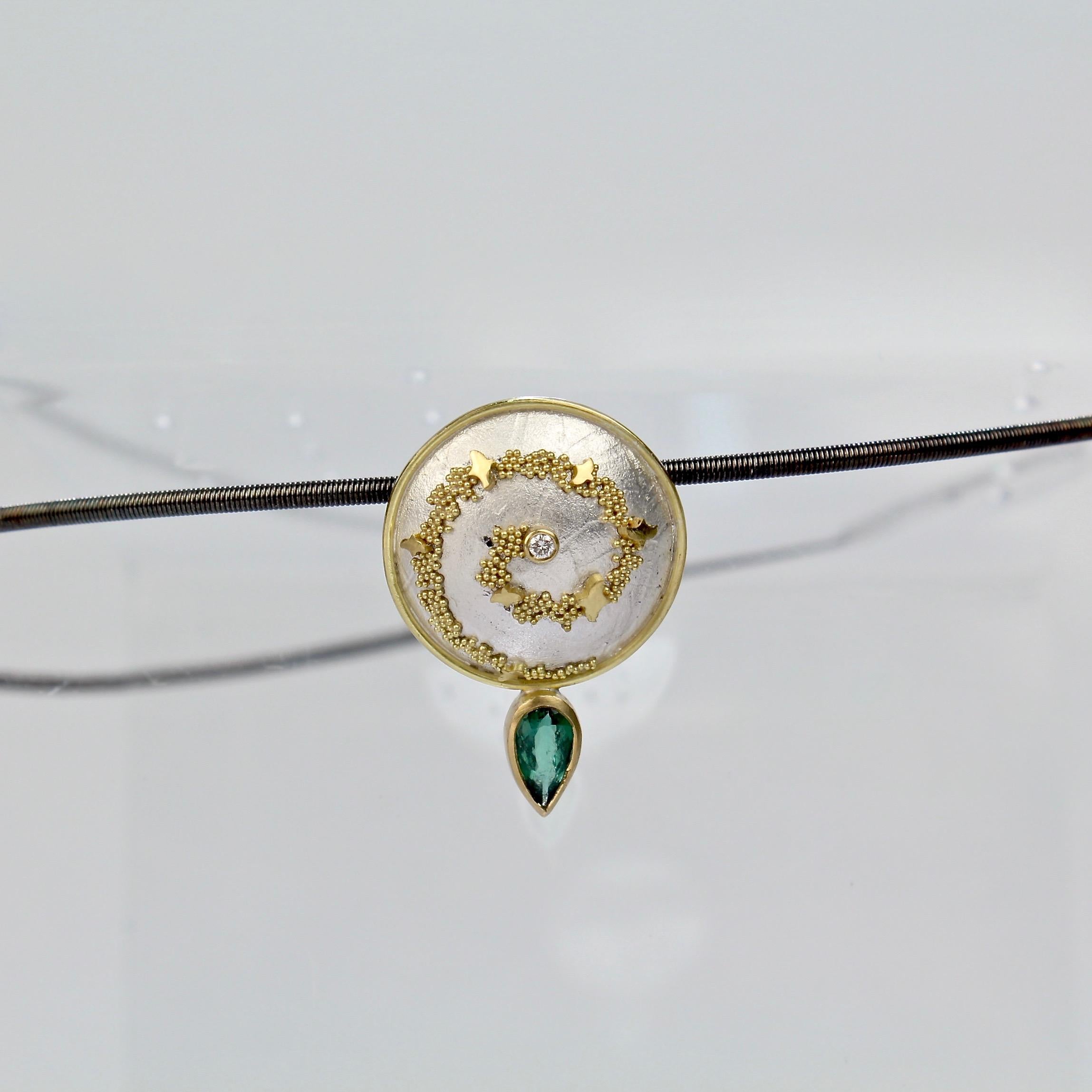 An elegant Cornelia Goldsmith choker necklace.  

The central sterling silver pendant is set with a spiral of high-karat granulated gold beads and a green tourmaline gemstone.  

Goldsmith is a renowned California contemporary jewelry maker and a