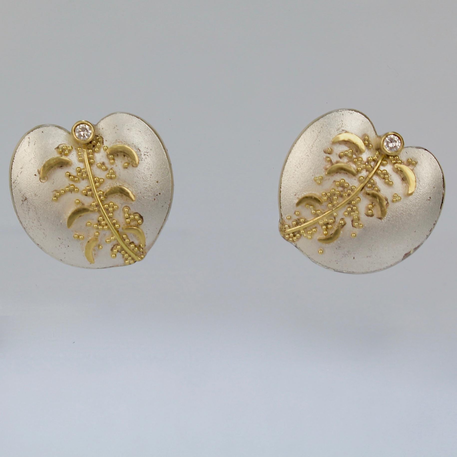 A wonderful pair of Cornelia Goldsmith stylized leaf form earrings.

Each in sterling silver with high karat granulated gold beads and set with a small round white diamond.

Goldsmith is a renowned California contemporary jewelry maker and a member