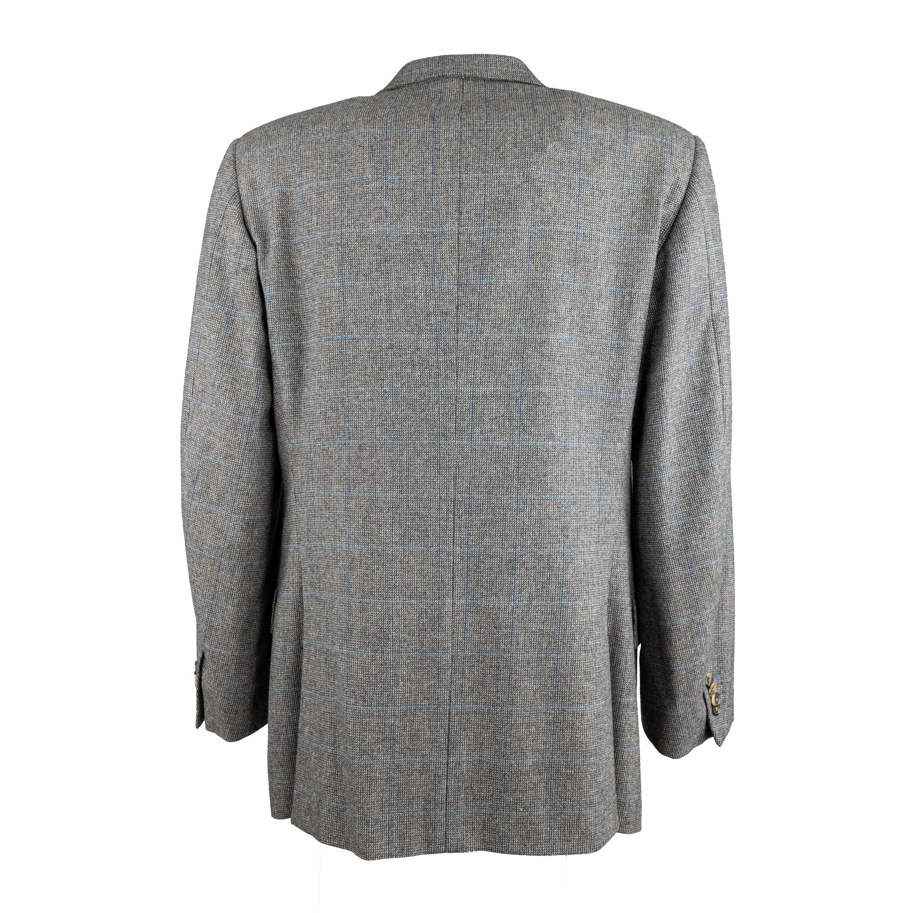 Crafted from the finest 100% virgin wool and super 120's thread, this Corneliani Checkered Blazer boasts an extra fine merino wool fiber. The elegant light grey hue is accentuated by a classic blue checkered pattern, complete with a notched lapel