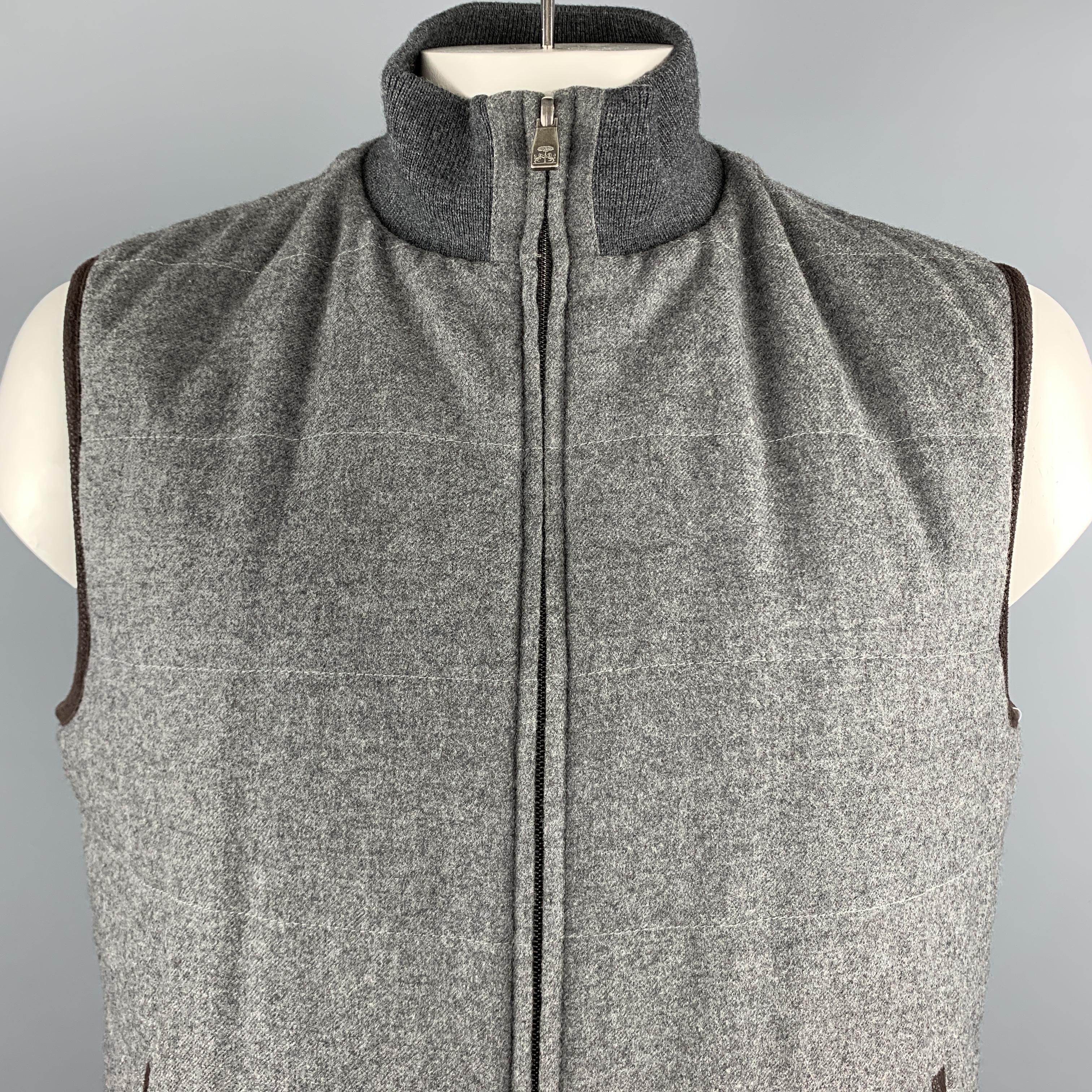 CORNELIANI Reversible vest comes in a gray quilted virgin wool material, with a high collar, a ribbed grey trim, a zipped front, and zip pockets. Made in Italy. 

Excellent Pre-Owned Condition.
Marked: 54 R

Measurements:

Shoulder: 18 in. 
Chest: