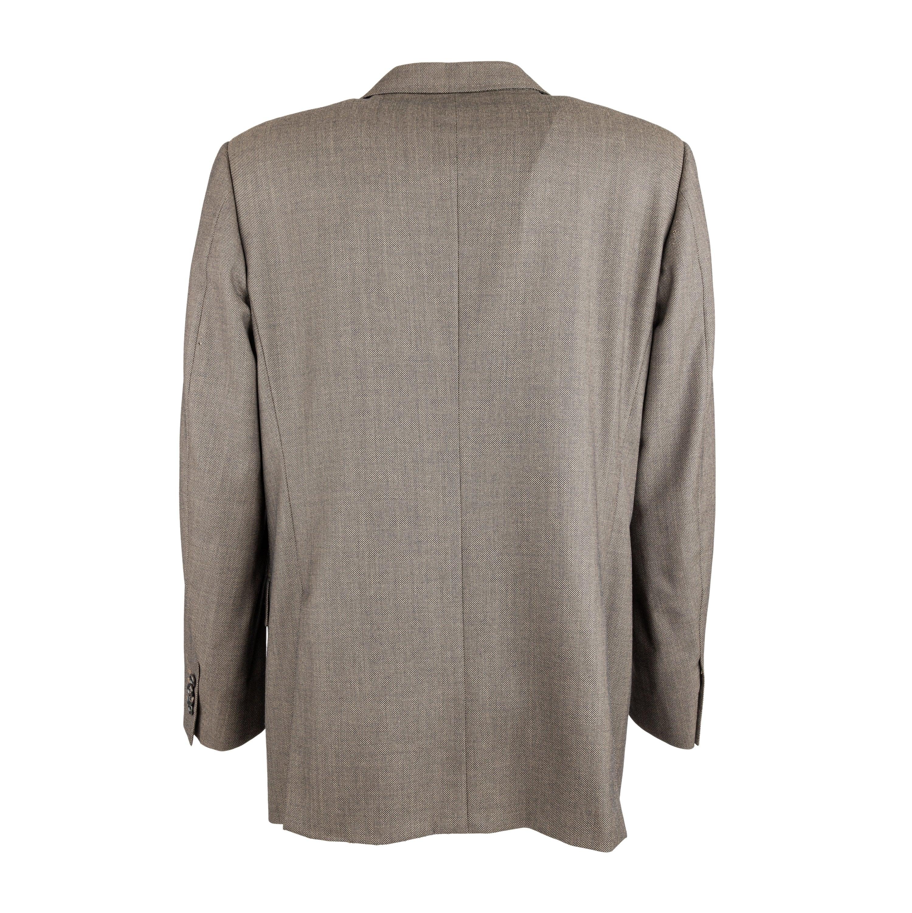 This Corneliani wool blazer features a unique dotted birdseye pattern fabric, made with 100% virgin wool in Super 110's extra fine thread for superior quality. The rich brown color is accented with black detailing, complementing the notched lapel