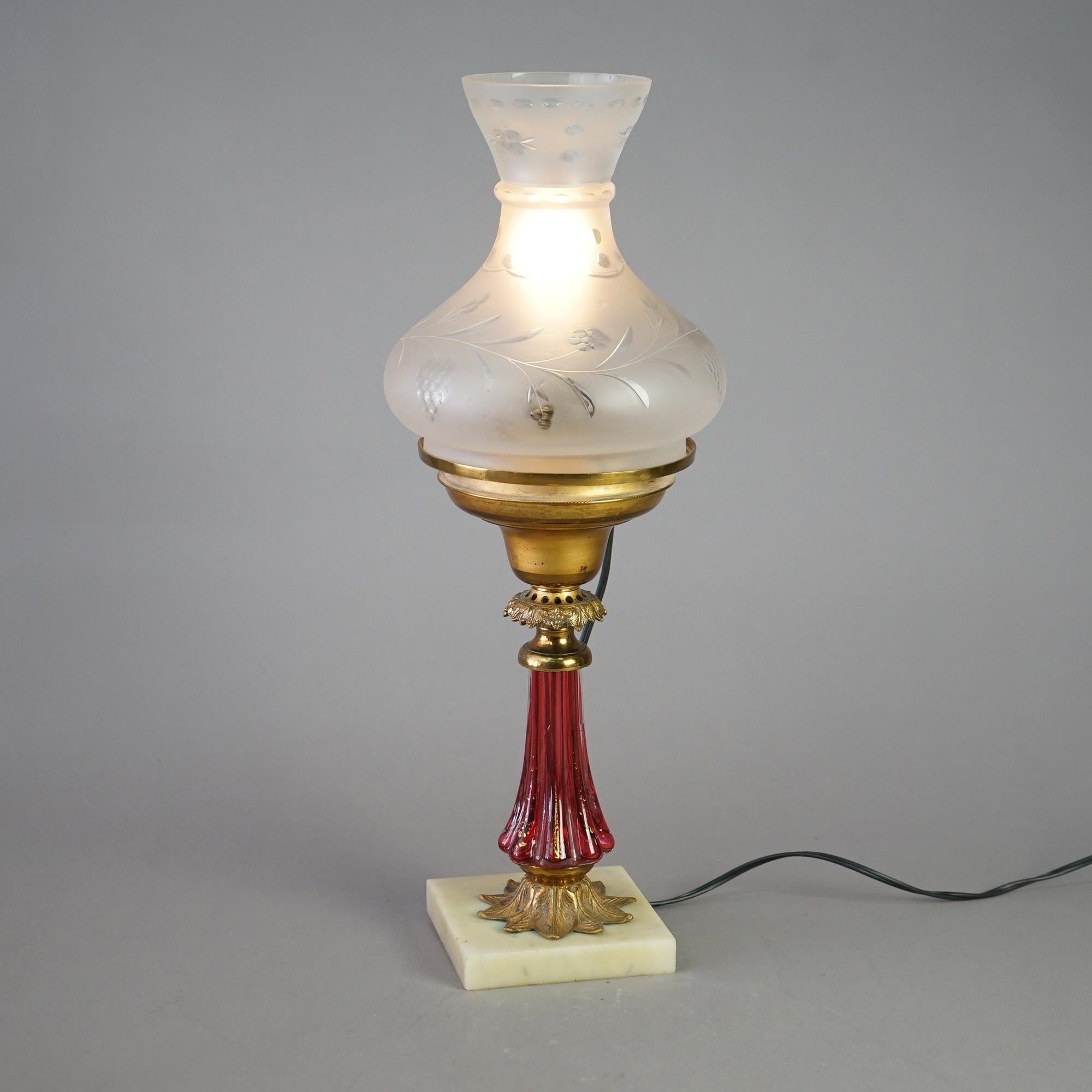 An antique solar lamp in the manner of Cornelius offers cutback glass shade over cranberry glass base on marble foot, electrified, c1850

Measures- 20.75''H x 7.5''W x 7.5''D