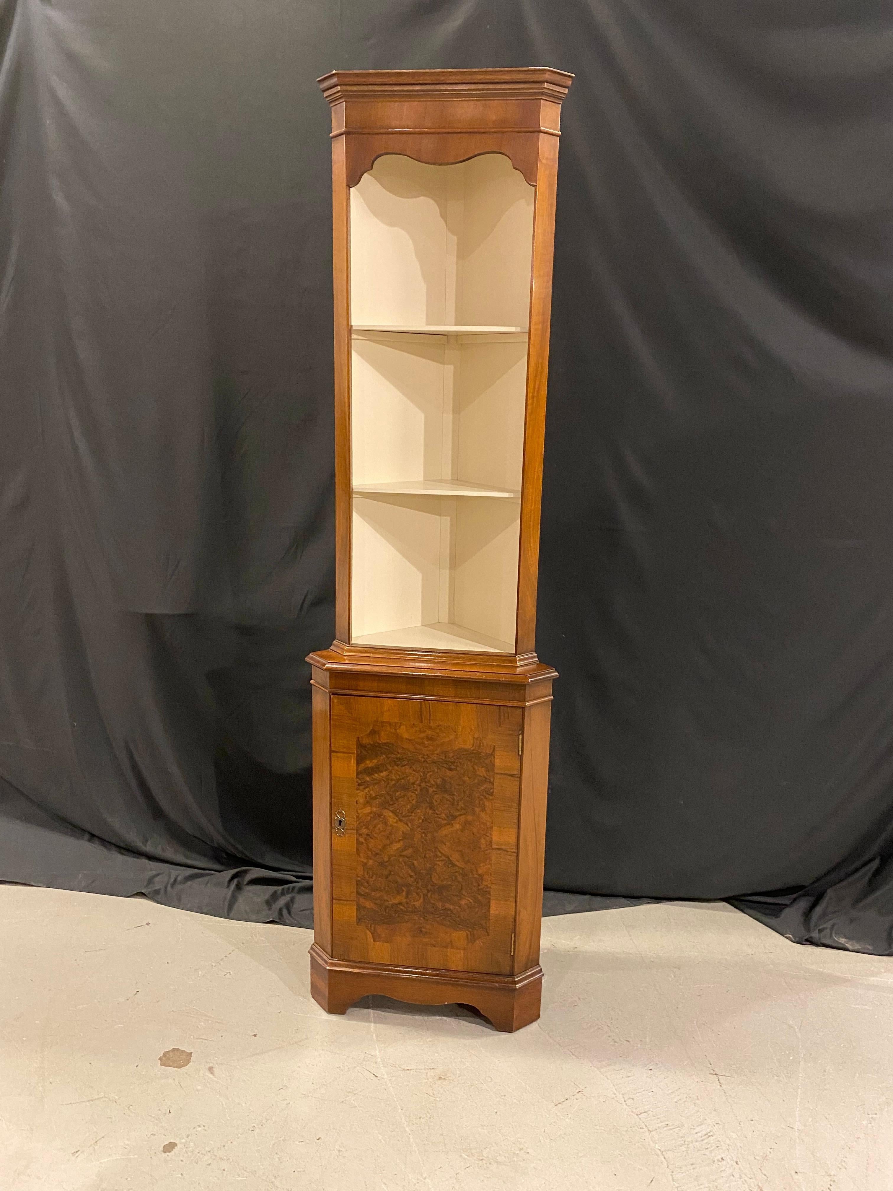 This dainty little open face corner cabinet in the 18th century styling was made in England by one of Britain's better known cabinet shops. Bevan Funnel made this cabinet in mahogany with a walnut burr center panel in the face of the lower door. The