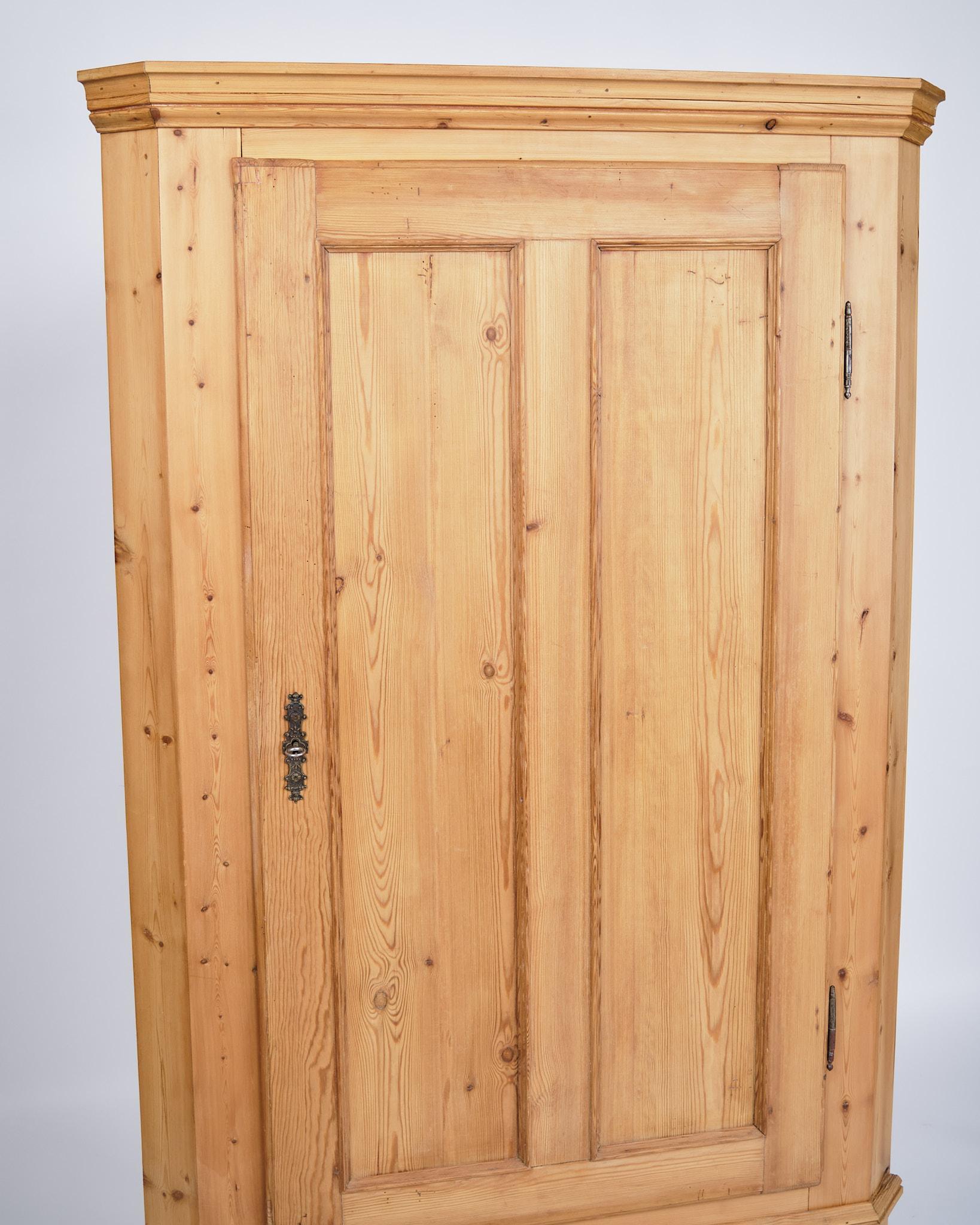 Antico mobile ad angolo degli anni '20 in legno di pino massiccio con accessori originali in ottone.

- Periodo: 1920s
- Materiale: Legno di pino massiccio, accessori in ottone
- Tipo: Armadio ad angolo
- Dimensioni: H: 170,5 cm, L: 96,5 cm, P: 54