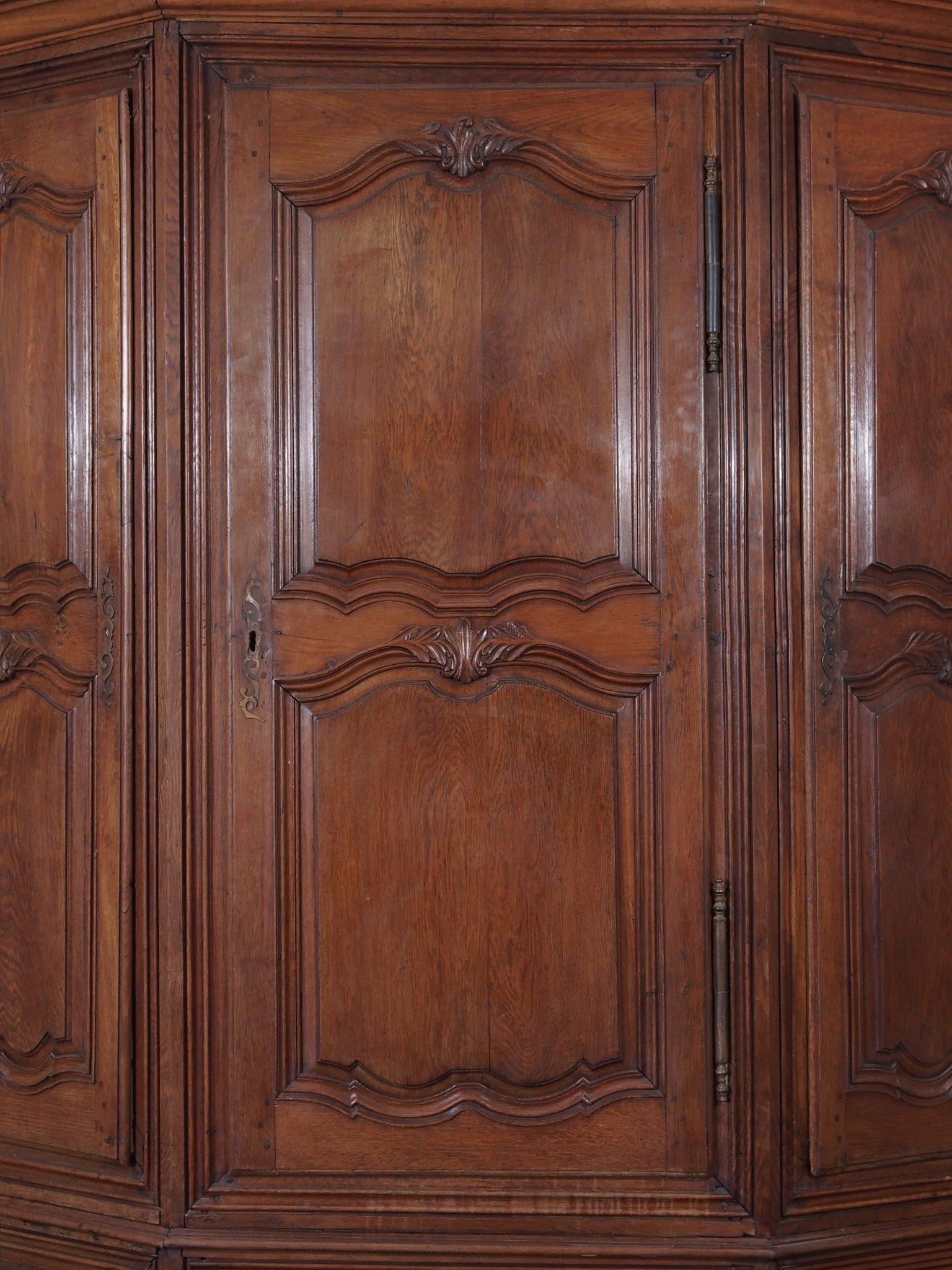 Gorgeous 18th century antique French Grande Louis XIV oak corner cabinet. This antique oversized oak corner cabinet mimics a stunning built in effect and will add architectural interest. Rich wood character and polished carving with lots of drawer