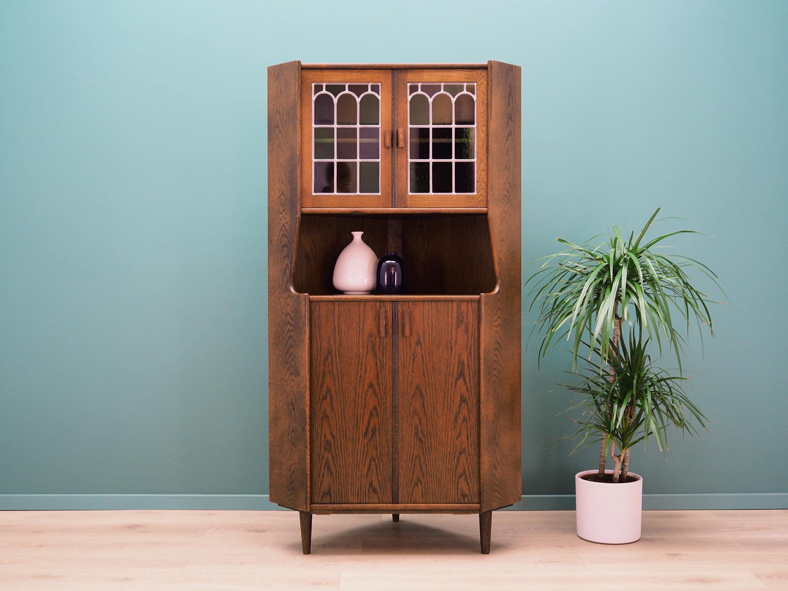 Cabinet was made in the 1960s, Danish production.

The construction is covered with oak veneer. The legs and handles are made of solid oak wood. The surface after refreshing. Inside the space has been filled with practical shelves with adjustable