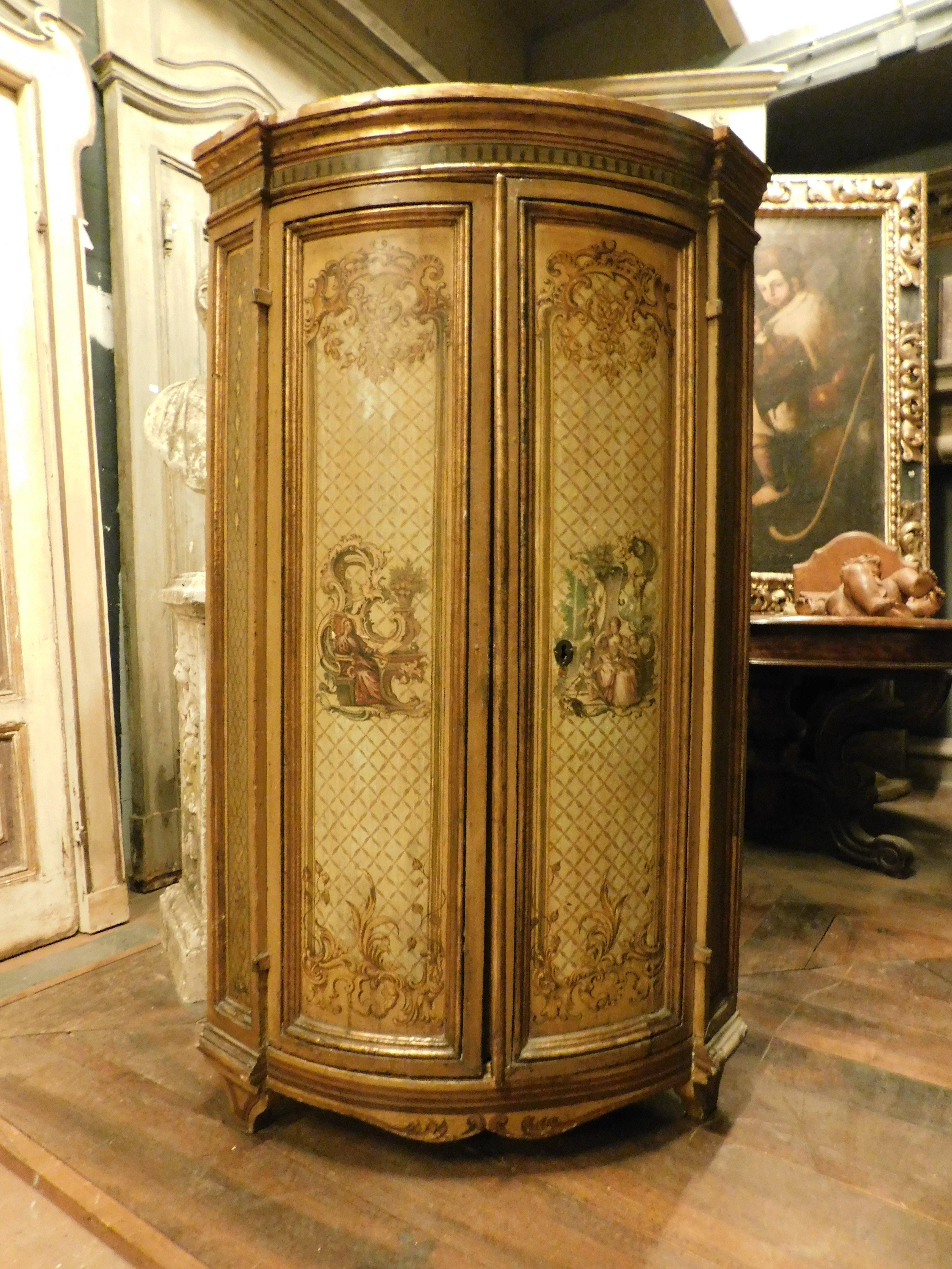 Ancient antique corner cabinet, lacquered cabinet on a yellow background and hand painted with baroque scrolls and romantic medallions, made in Italy (from Rome), from the 18th century, with original ironwork and shelves inside, maximum measurement