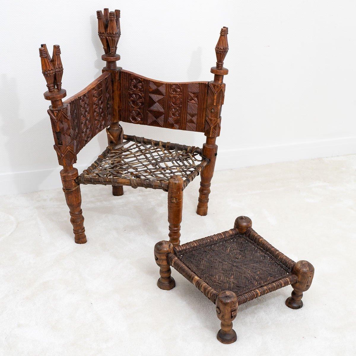 Magnificent set of two honorary chairs and a footrest made of solid cedar wood, handcrafted in the purest tradition of Nuristan in Afghanistan with woven leather covering. 

Period : 19th century
Circa : 1885 - 1890
Dimensions : Armchair 1 : Height
