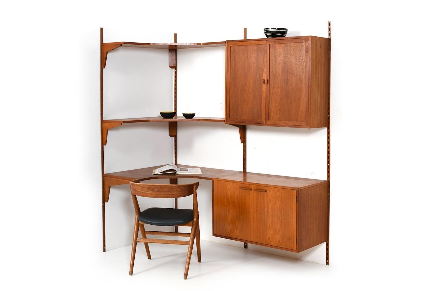 Kai Kristiansen corner wall system in teak. Manufactured by FM Feldballes Møbelfabrik Denmark in 1960s. As usual very good quality with equally beautiful patina.
The wall unit consists of:
- 3 shelves
- 2 cabinets
- 4 wall brackets

detailed