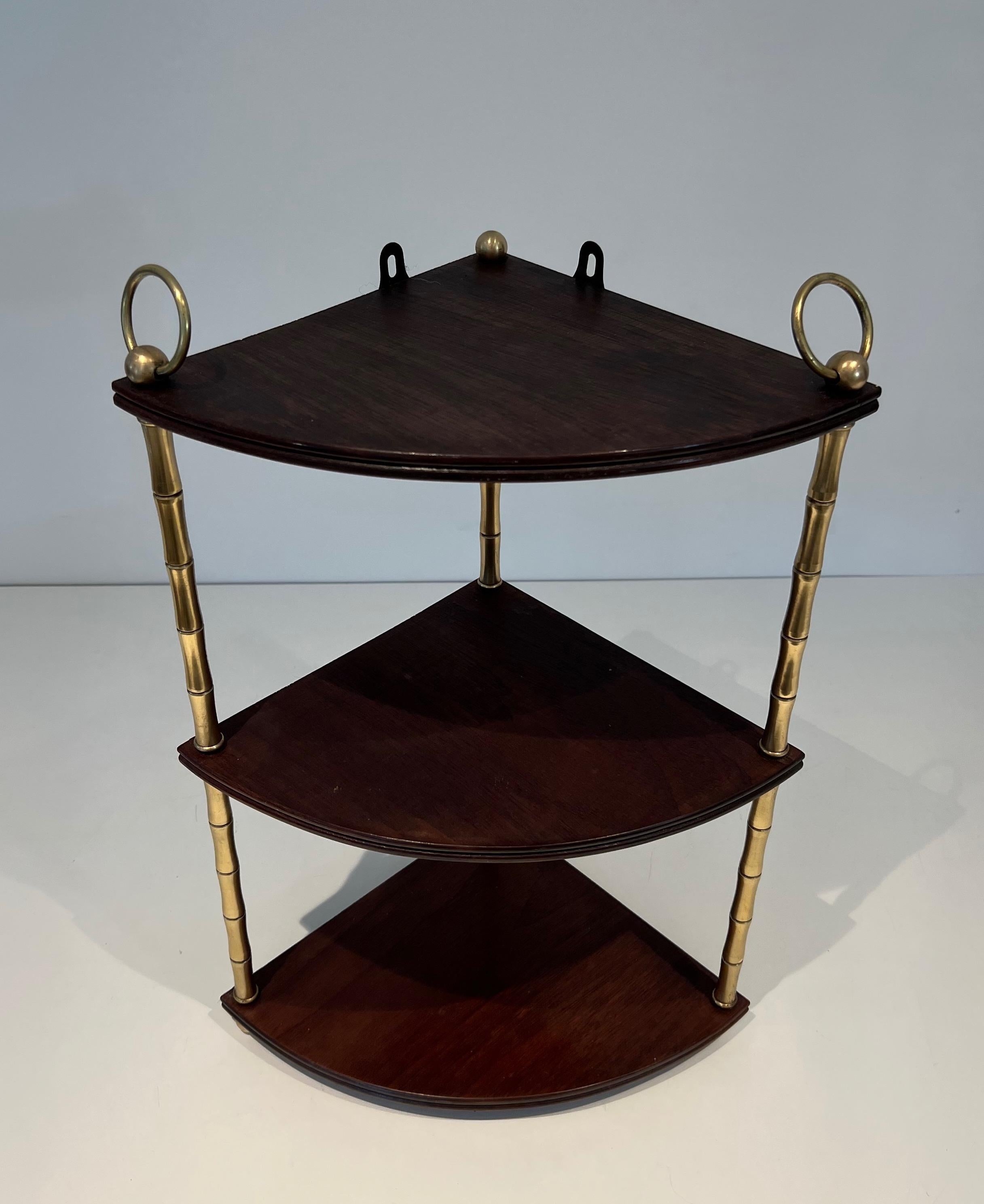This very nice corner shelves is made of faux-bamboo brass and mahogany. This is a French work in the Style of Maison Baguès. Circa 1940