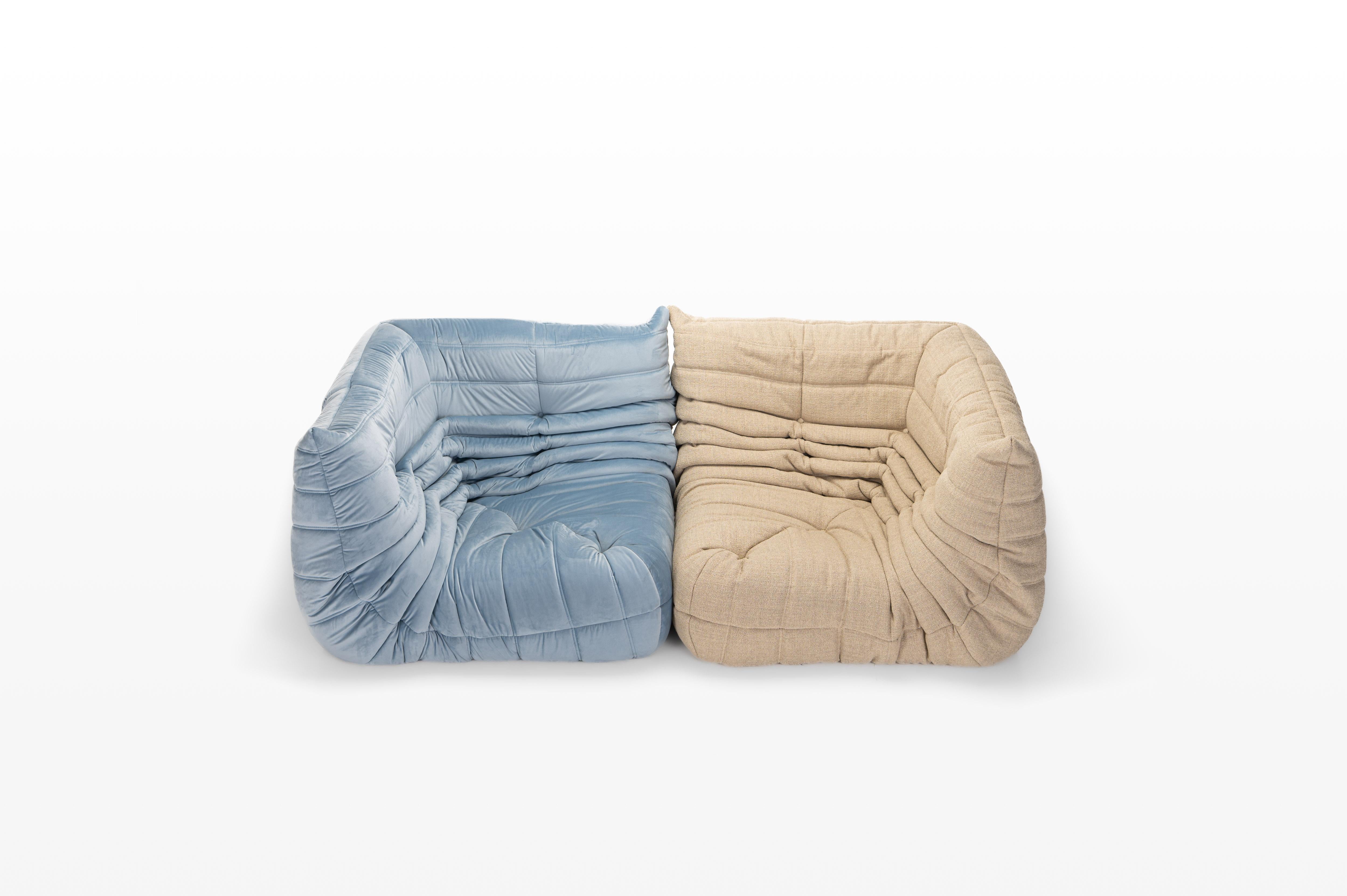 Beautiful cream beige Togo and blue velvet lounge chairs designed by Michel Ducaroy for Ligne Roset. The set contains two corner elements and the sofas are reupholstered. Price for the set.