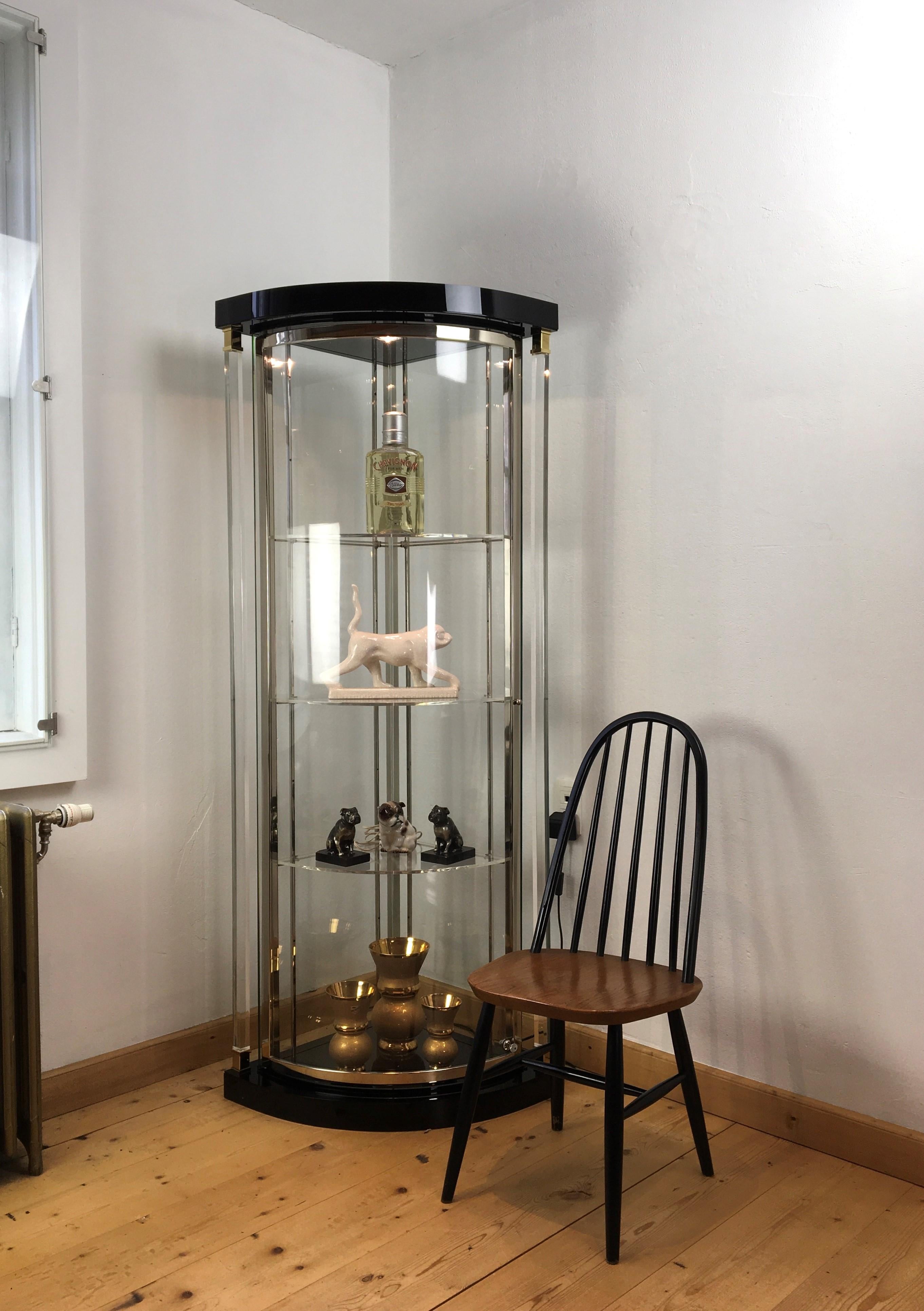 Corner vitrine by Belgo Chrome.
A spectacular Belgo Chrom showcase with glass at the sides, lucite door, lucite pillars left and right, lucite shelves inside and also lighting. Above and under the acrylic pilars 23KT gold plated finish ornaments.