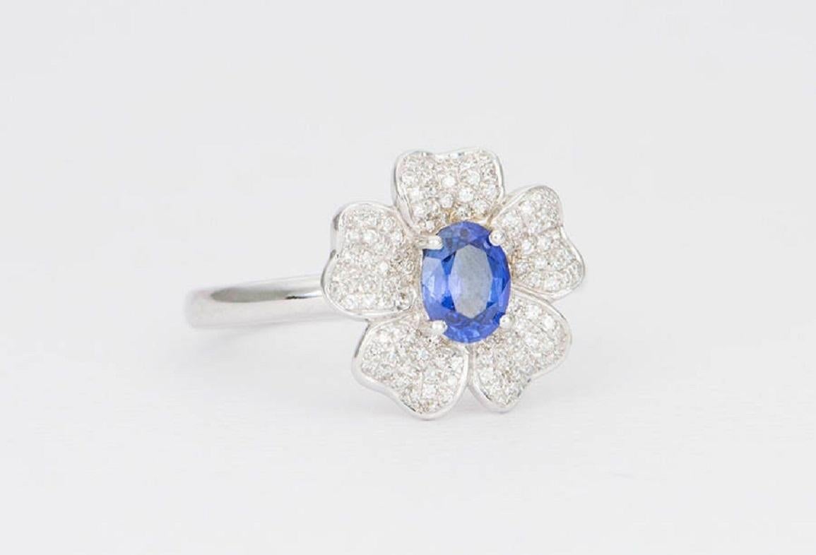 ♥  This is a stunning ring set with a small oval blue sapphire in the center, surrounded by 5 flower petals encrusted with white diamond paves.
♥  The setting is intentionally designed to sit higher on the finger to allow stacking rings. You should