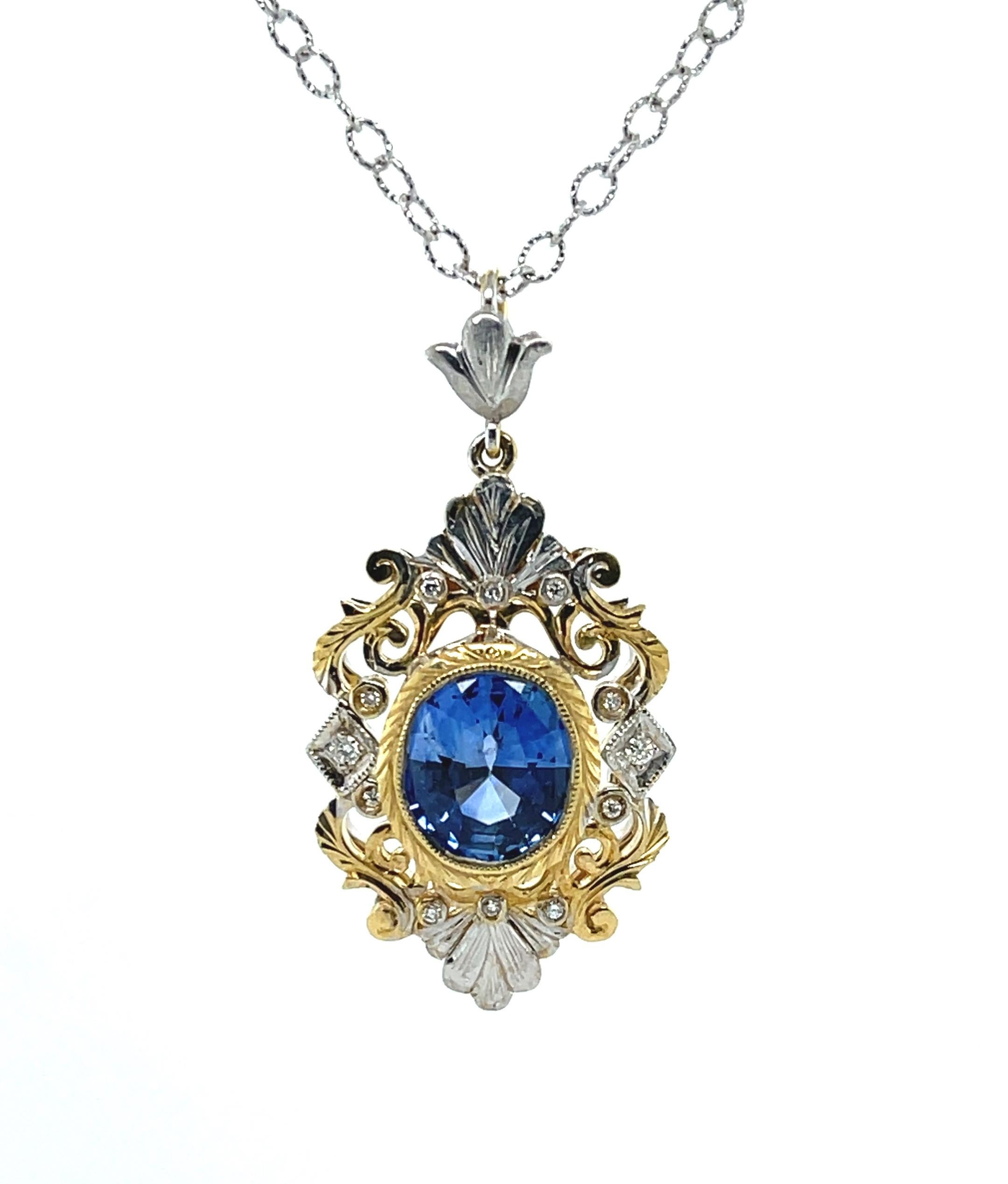 Feel like a royal in this beautifully handmade and intricately designed 18k yellow and white gold sapphire pendant! This gorgeous necklace features a beautiful 2.29 carat Ceylon blue sapphire oval of highly-prized 