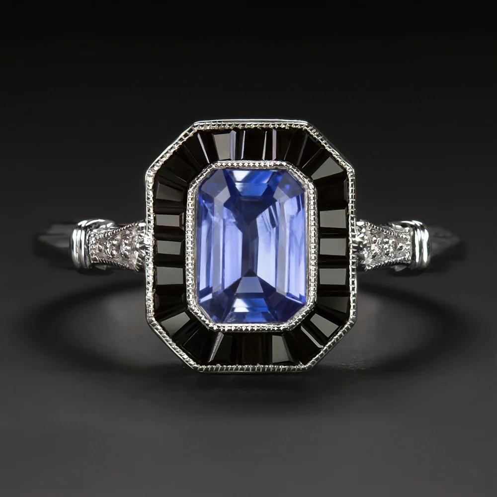 bold and gorgeous contrast! The ring features a 0.92ct cornflower blue sapphire surrounded by a halo of calibre cut natural black onyx. Eye-catching and classically fashionable, this ring beautifully captures the class and glamour of Art Deco