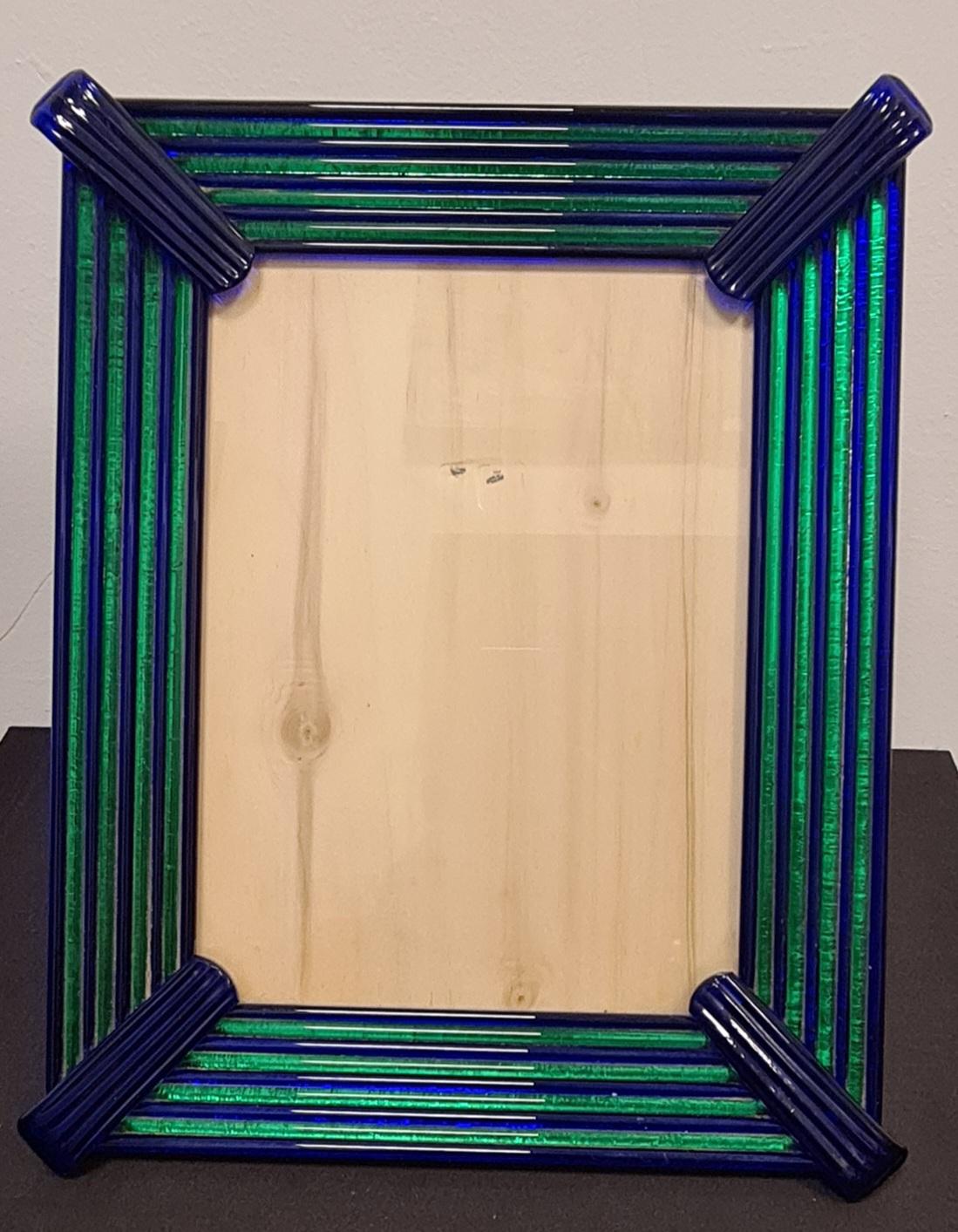 Fine glass frame attributable to master glassmaker Archimede Seguso.

The chronice is composed of blue and green murano glass rods , alternating.

Glass rods are arranged on a lacquered wooden stand.

Archimede Seguso was one of the greatest master