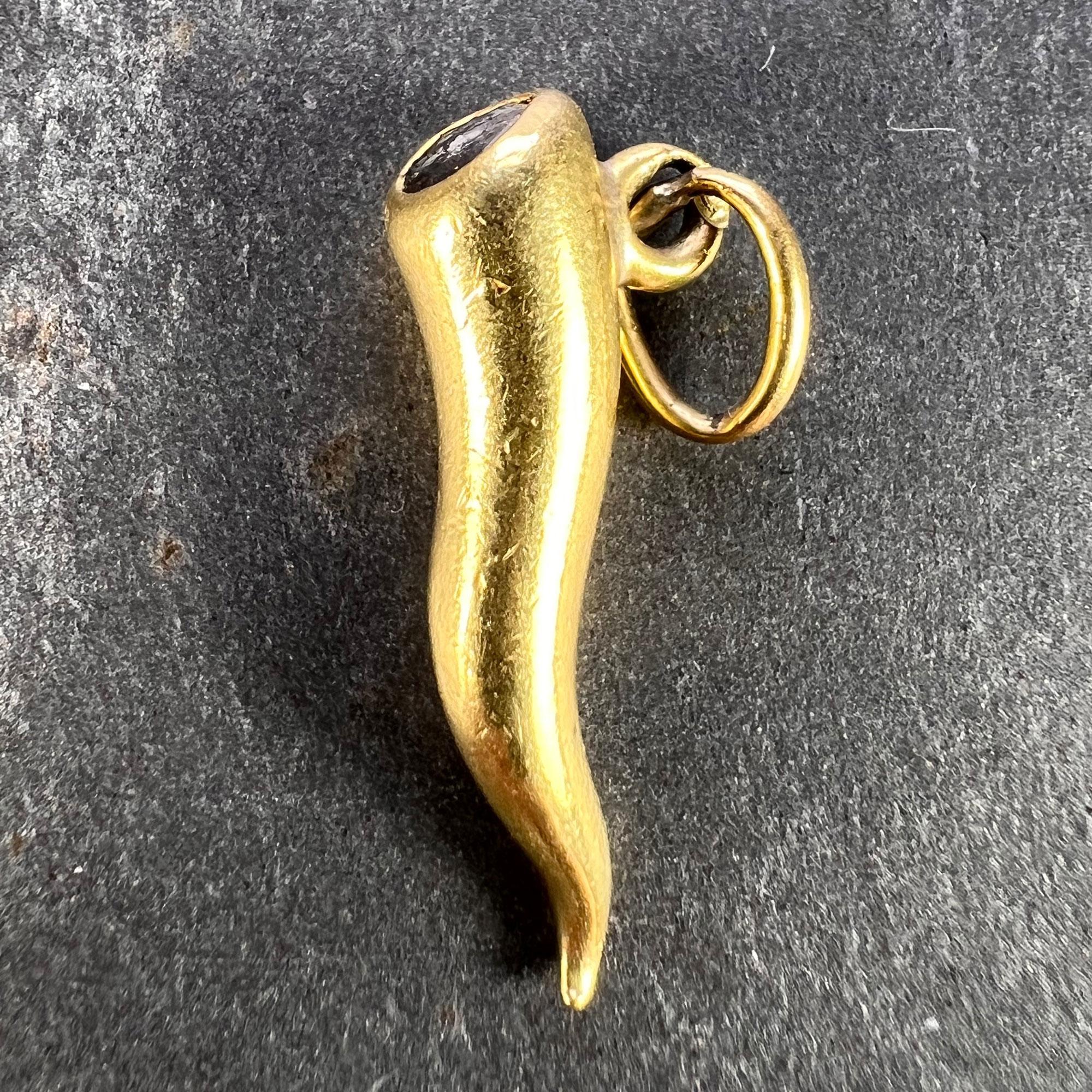 An 18 karat (18K) yellow gold charm pendant designed as a cornicello or lucky horn set with a rose cut diamond measuring 0.4 x 0.4mm to the top. Stamped with the French import mark for 18 karat gold to the bail.

Dimensions: 2.1 x 0.8 x 0.5 cm (not