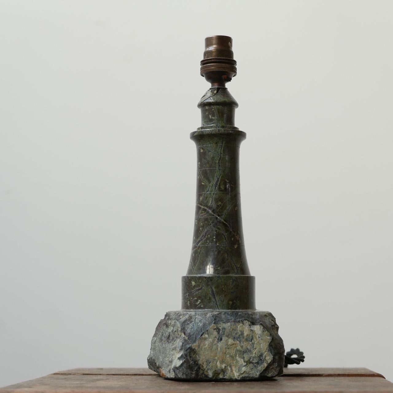 A Cornish marble stone table lamp.

Likely carved in the form of a lighthouse.

Cornwall, England, mid-late 20th century.

Re-wired with black silk flex.

   

Historical repair to top of the lamp (see photos).

Dimensions: 11 W x 10 D x