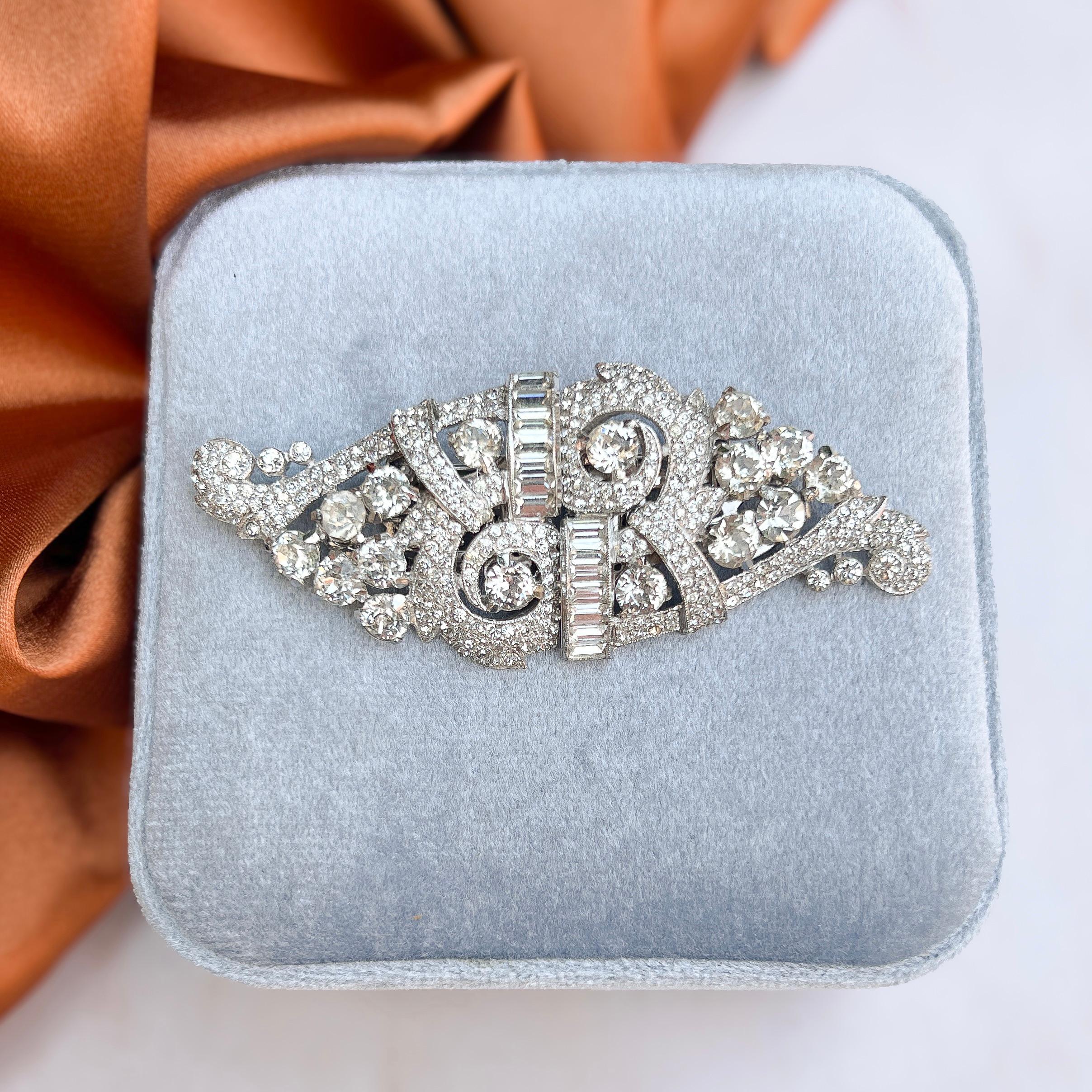 This delightful Duette clip brooch was designed and made by Coro in the 1930s.  

Condition Report:
Excellent

The Details...
This Duette clip brooch is constructed from rhodium plated metal and is detailed with round and baguette cut paste stones,