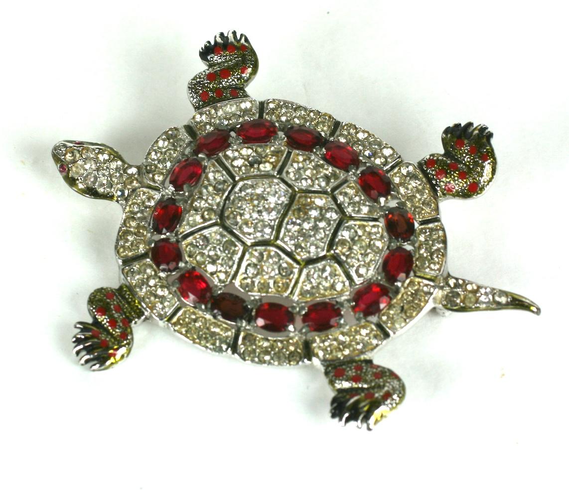 Large and striking Coro Art Deco Pave Turtle Brooch from the 1940's. Body is completely set with pave rhinestones with oval cut faux rubies and highlighted with colorful enamel accents. 1940's USA. Signed.
3.75