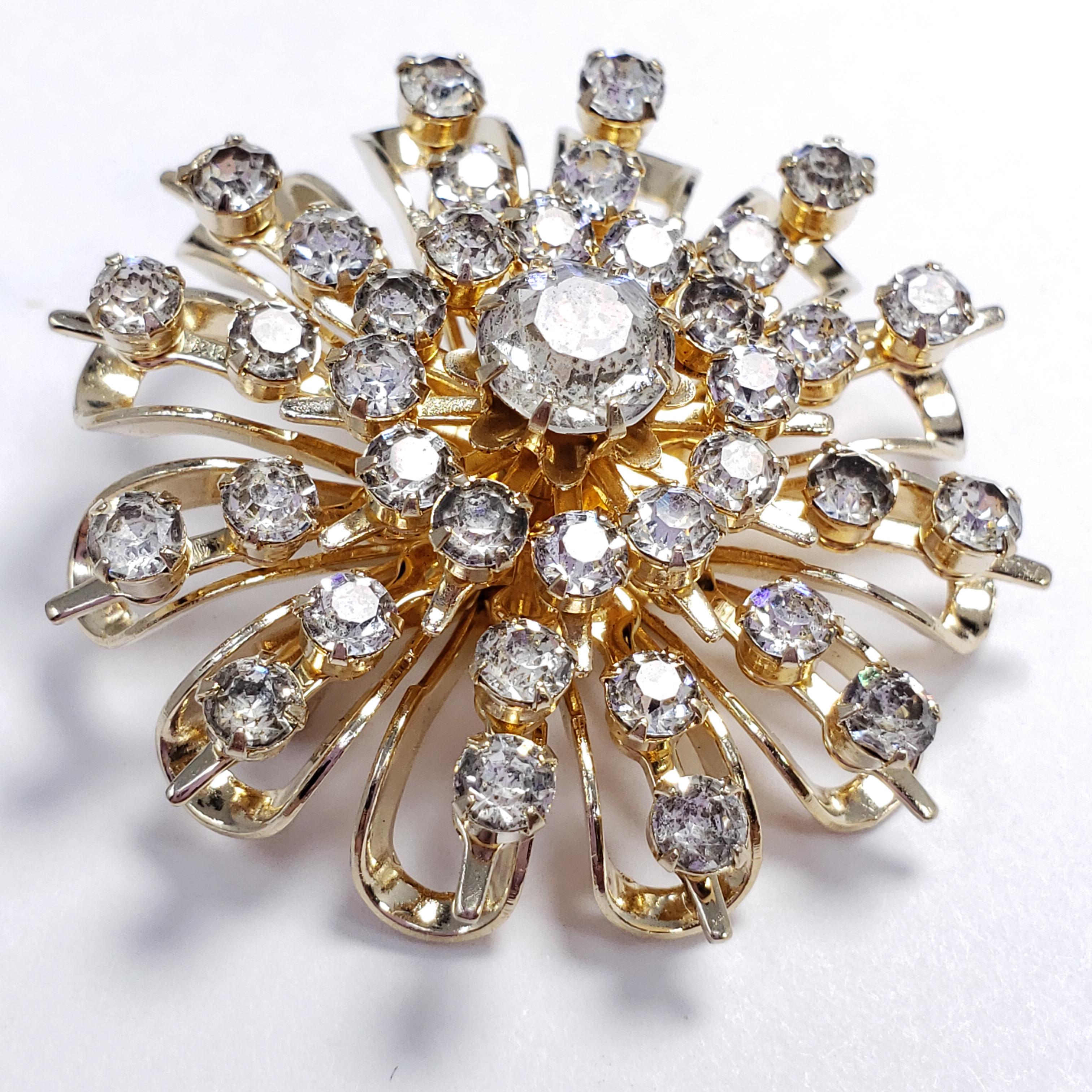 A vintage collector's pin brooch by Coro. Features a gold-tone flower motif accented with clear, prong-set crystals. A mesmerizing accessory!

Hallmarks: Coro, DES Pat Pend