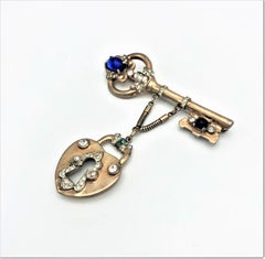 Coro Craft brooch in the shape of a key with attached lock sterling gold plated