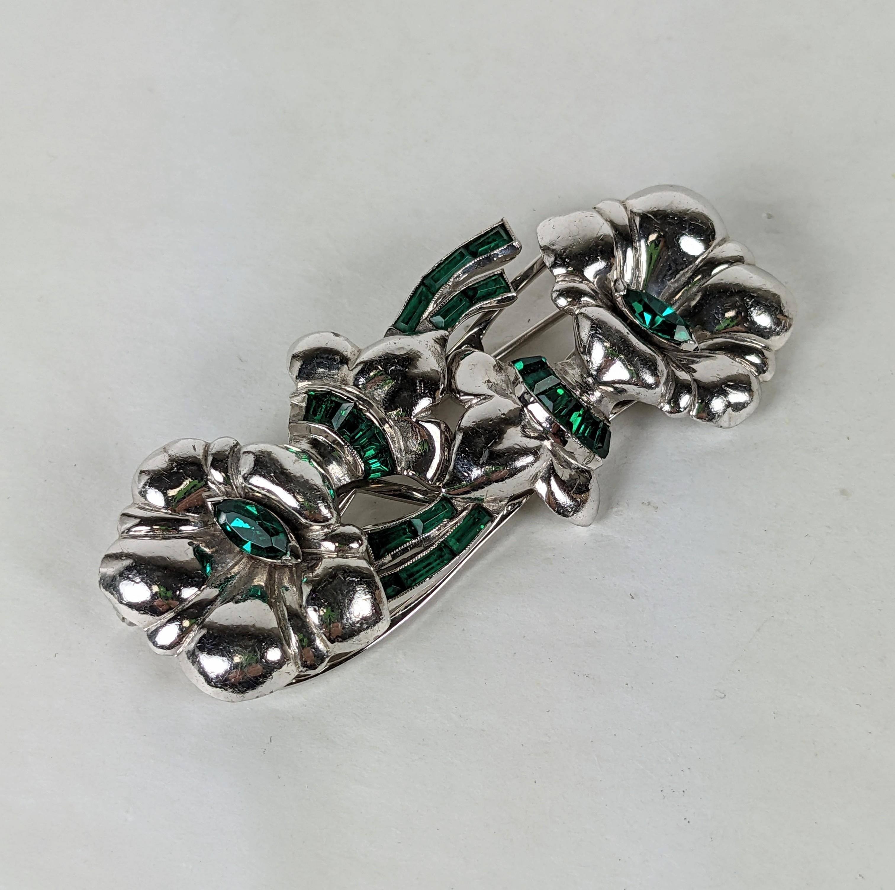 Unusual Coro Deco Flower Duette from the 1930's. Rhodium plated lily flower clips set with with green pastes. Both clips separate of backing and can be worn along a neckline or as a brooch.
2.75