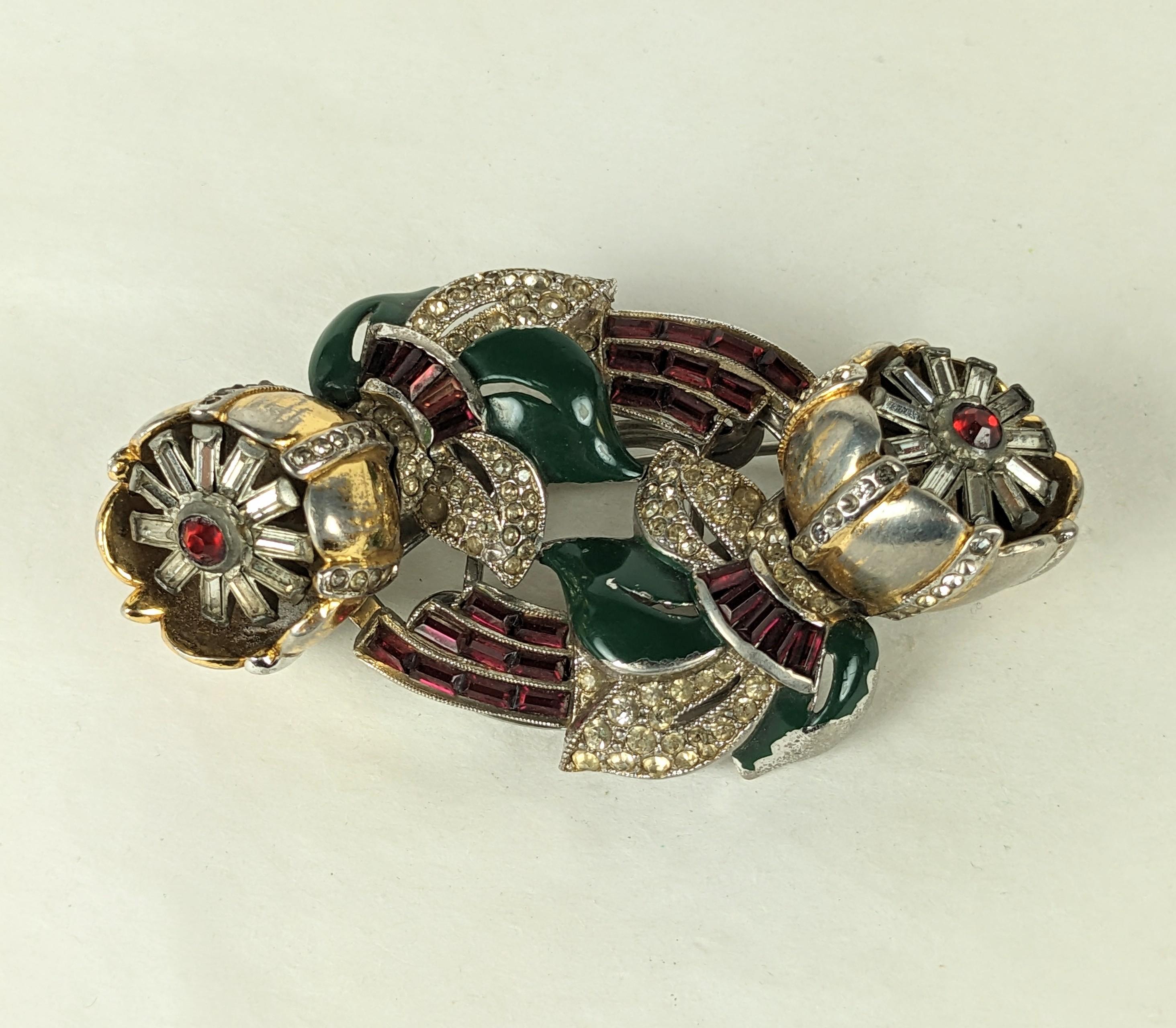 Coro classic flower twist tremblant duette brooch of gilt metal, green enamel, ruby crystal baguettes and crystal pastes. Both flower clips separate off base to be worn separately. 1940's USA. 
Length  3