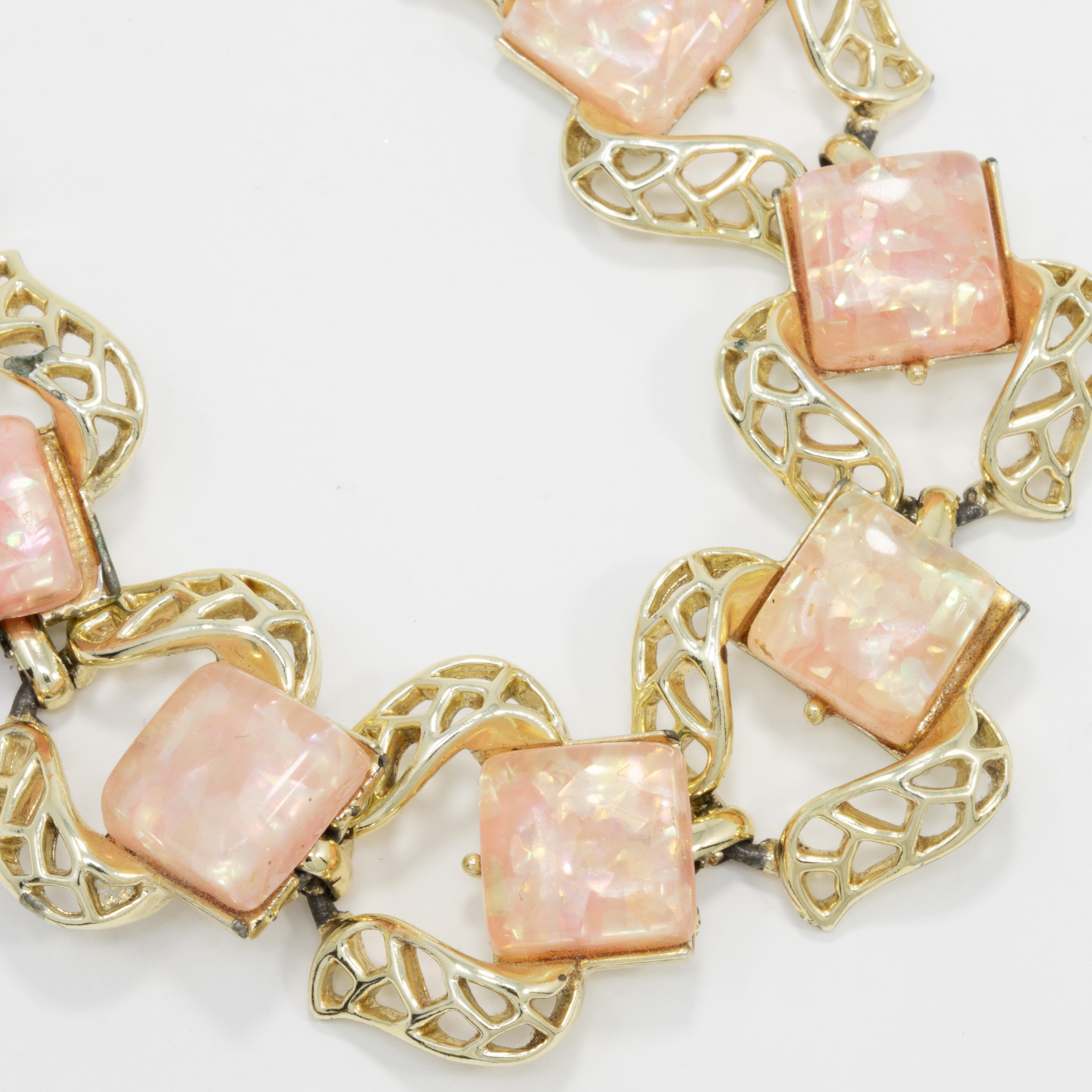 Stylish link bracelet by Coro, featuring pink quartz crystals on accented golden links.

Gold-plated. Faux-quartz. Fold-over snap clasp.

Marks / hallmarks / etc: Coro