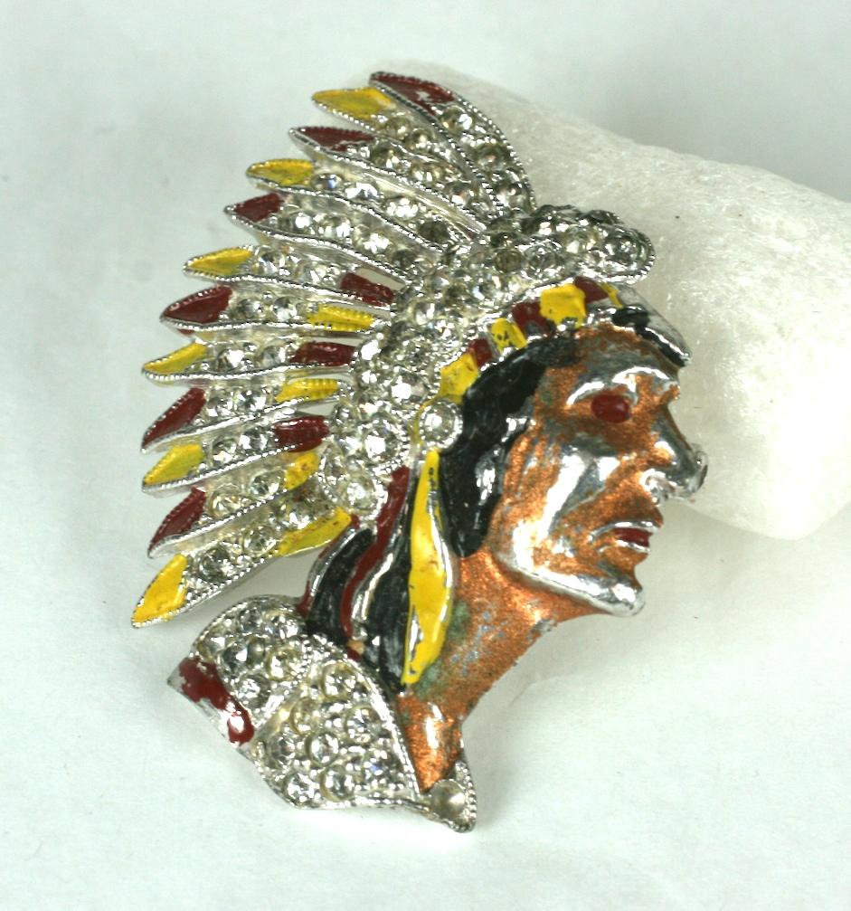 Coro American Indian Chief brooch in full headress of multi color cold enamel and crystal pave rhinestones. Set in rhodium plated metal. 1930's USA Unsigned.
Length  1.78 