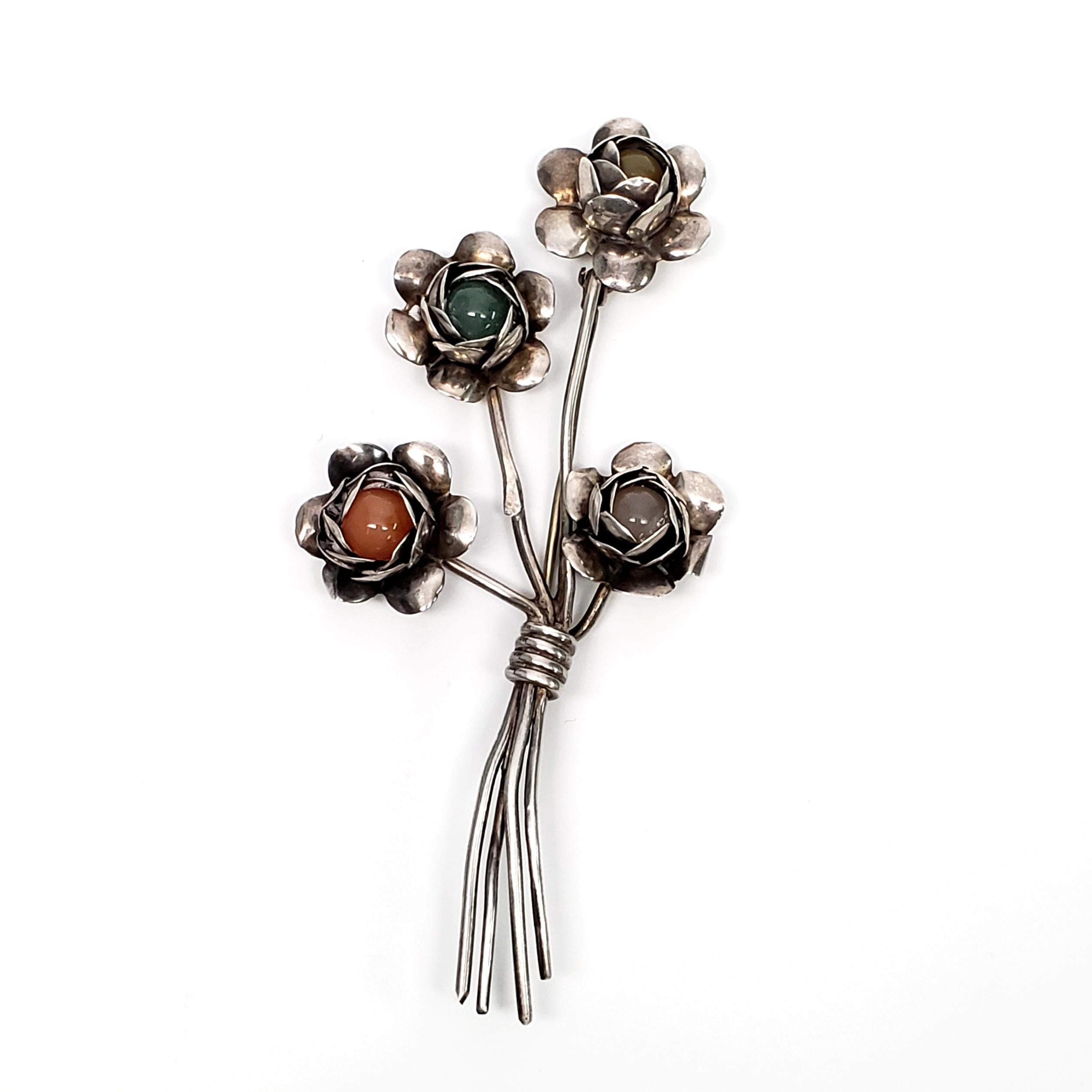 Vintage Coro sterling silver flower pin.

Flowers have multi colored beads within thin sterling silver petals.

Measures 4 1/8