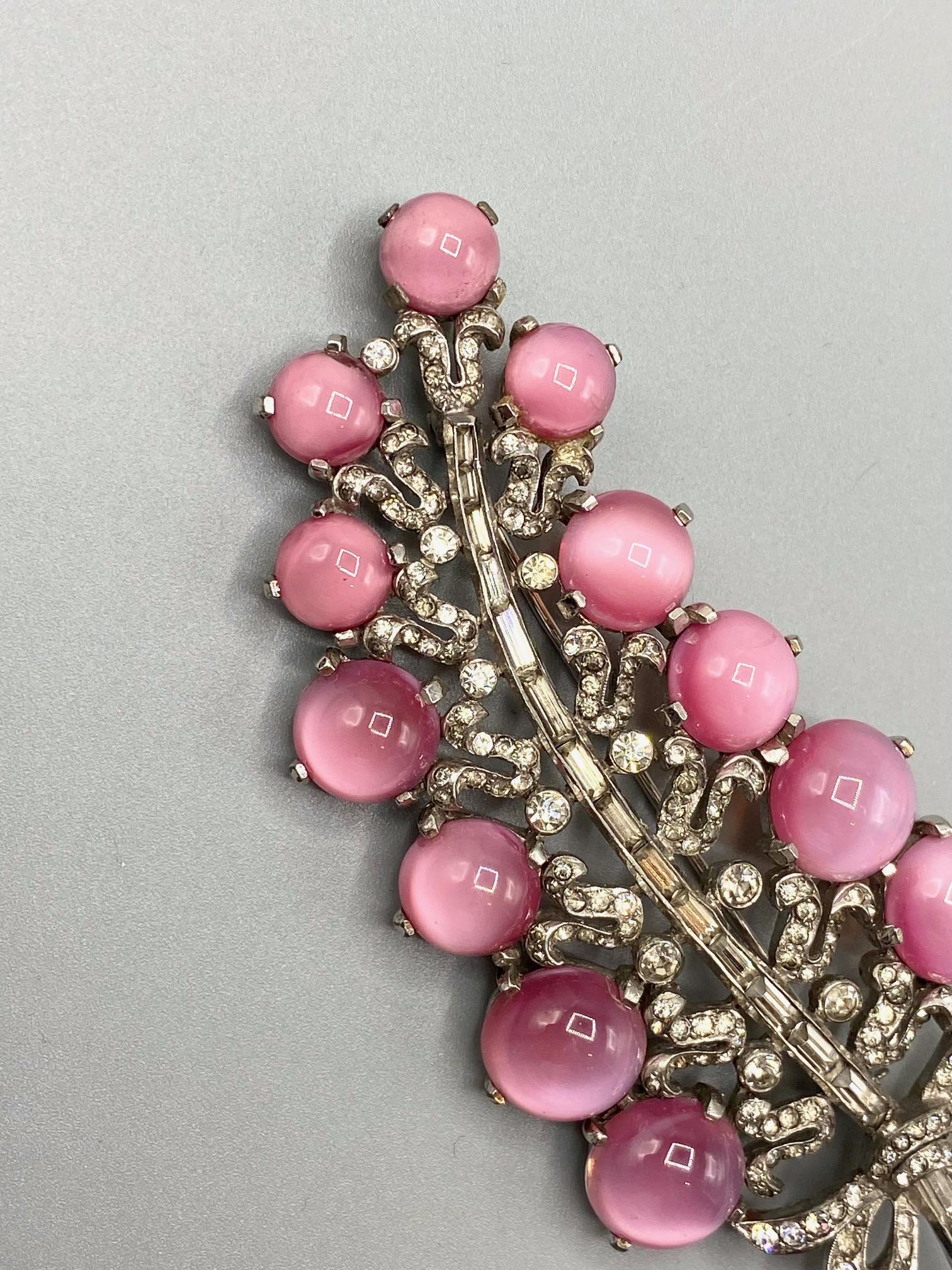 An absolutely stunning and rare unsigned 1940s brooch attributed to Coro. The brooch is top quality with rhodium plating, faux pink glass moonstones, round and baguette rhinestones. It is unmistakably by one of the top costume jewelry companies.