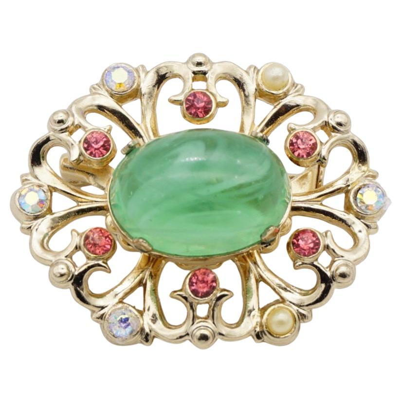 Coro Vintage 1950s Flower Emerald Green Cabochon Aurora Pink Crystals Pearls Openwork Brooch, Gold Tone

Very good condition. 100% Genuine.

A very beautiful brooch, signed at the back.

Material: Gold plated metal, Rhinestones, Faux pearls.

Size: