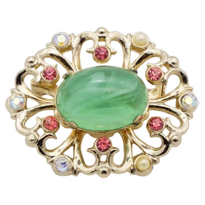 Coro Vintage 1950s Flower Emerald Green Cabochon Aurora Pink Crystals Pearls Openwork Brooch, Gold Tone

Very good condition. 100% Genuine.

A very beautiful brooch, signed at the back.

Material: Gold plated metal, Rhinestones, Faux pearls.

Size: