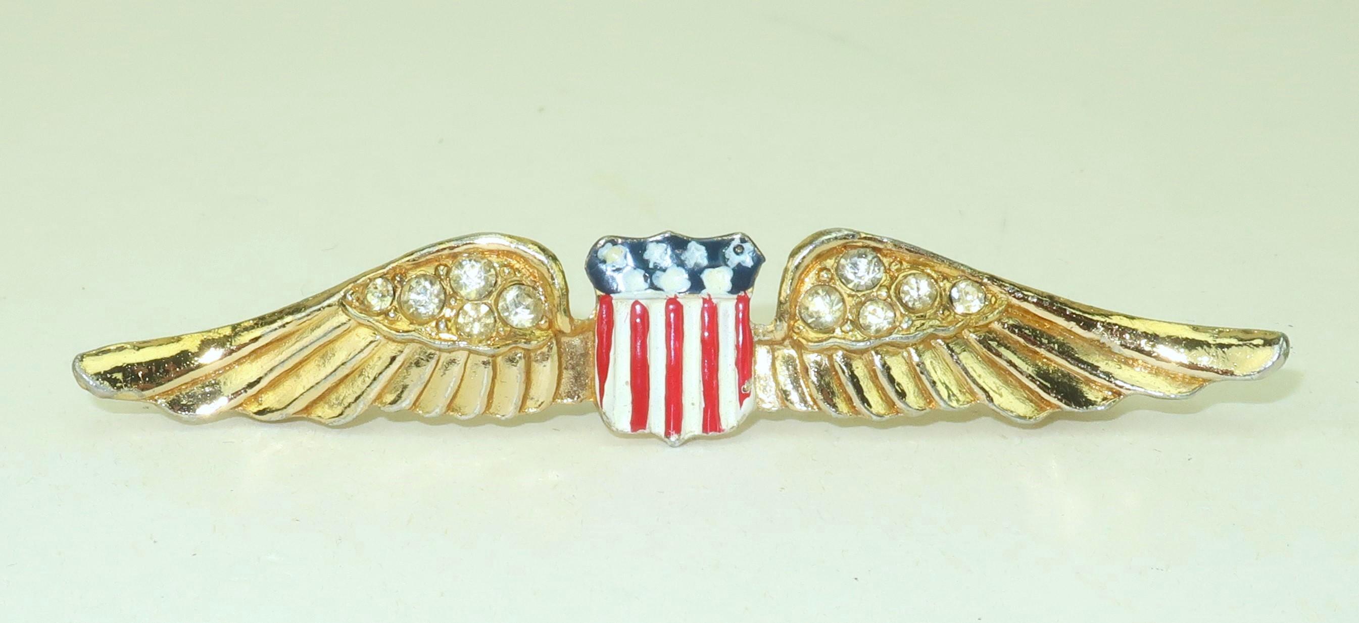 Patriotically chic!  World War II era brooch in the form of U.S. military wings … nostalgically referred to as ‘Sweetheart Wings’.  The brooch was produced by Coro in a gilt metal with red, white and blue enameling accented by crystal rhinestones. 