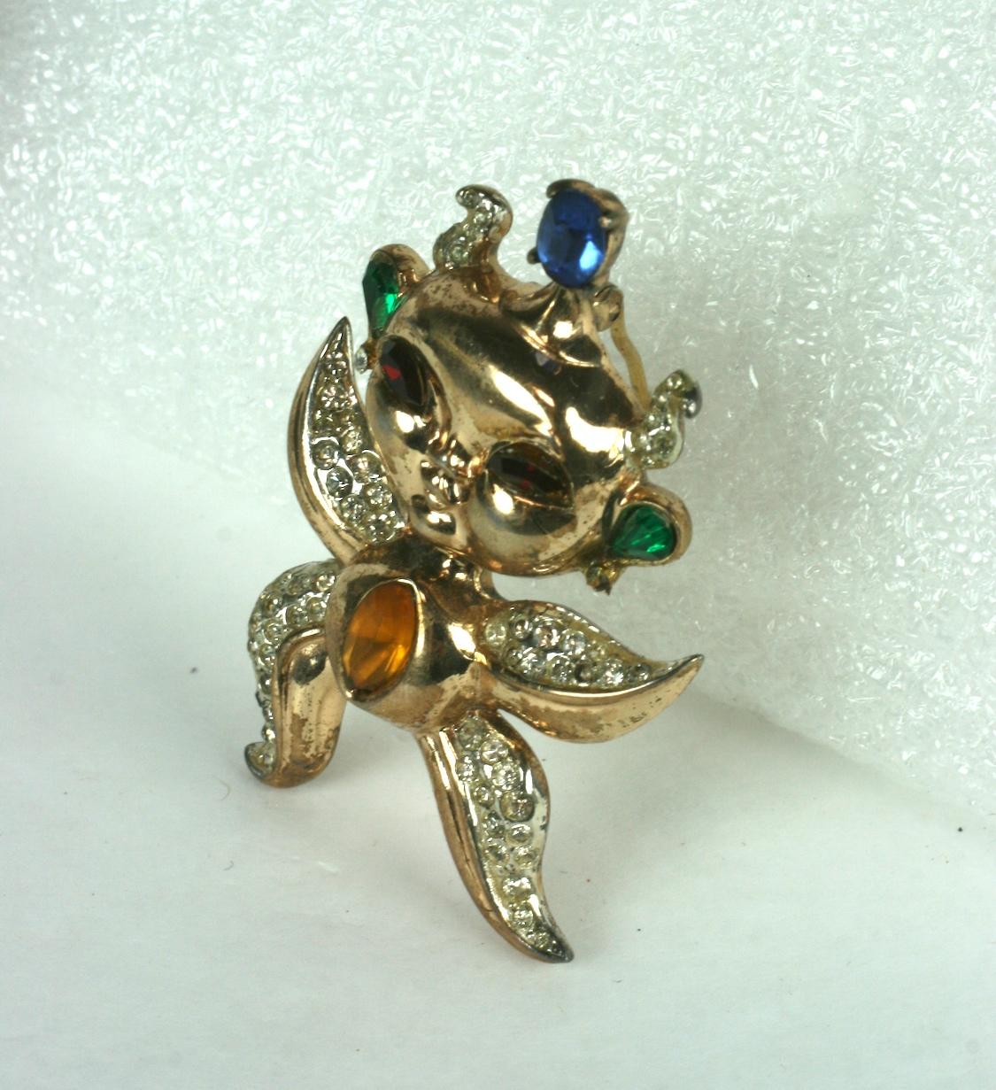 Charming Corocraft Sterling Vermeil Pixie Brooch from the 1940's. Adorable pixie alien with starfish like body decorated with pave accents and colored crystals. High quality casting in sterling with gold wash.
Very good condition.  2.25