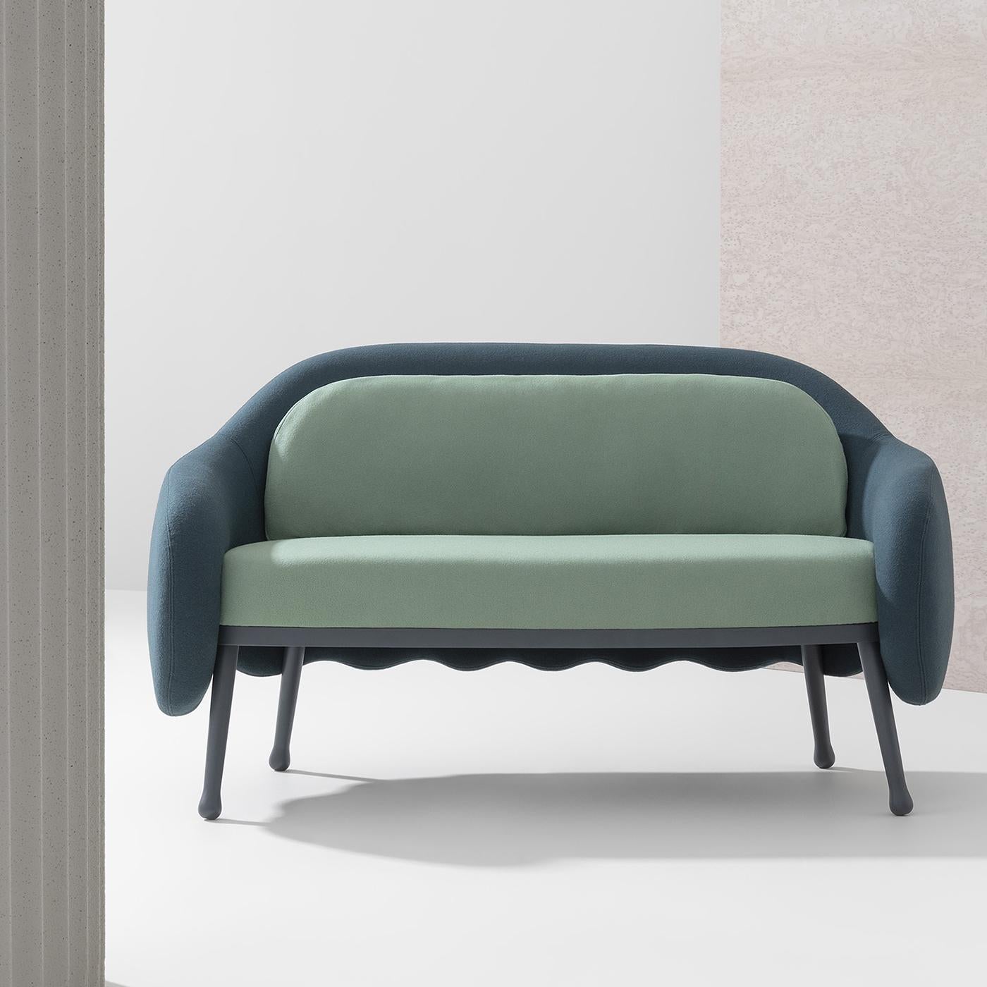 Contemporary flair and refined, durable materials merge in this exquisite sofa by Cristina Celestino. Resting on gray-lacquered beechwood legs with round feet and small felt pads, the padded seat and back cushions are upholstered of a pastel green