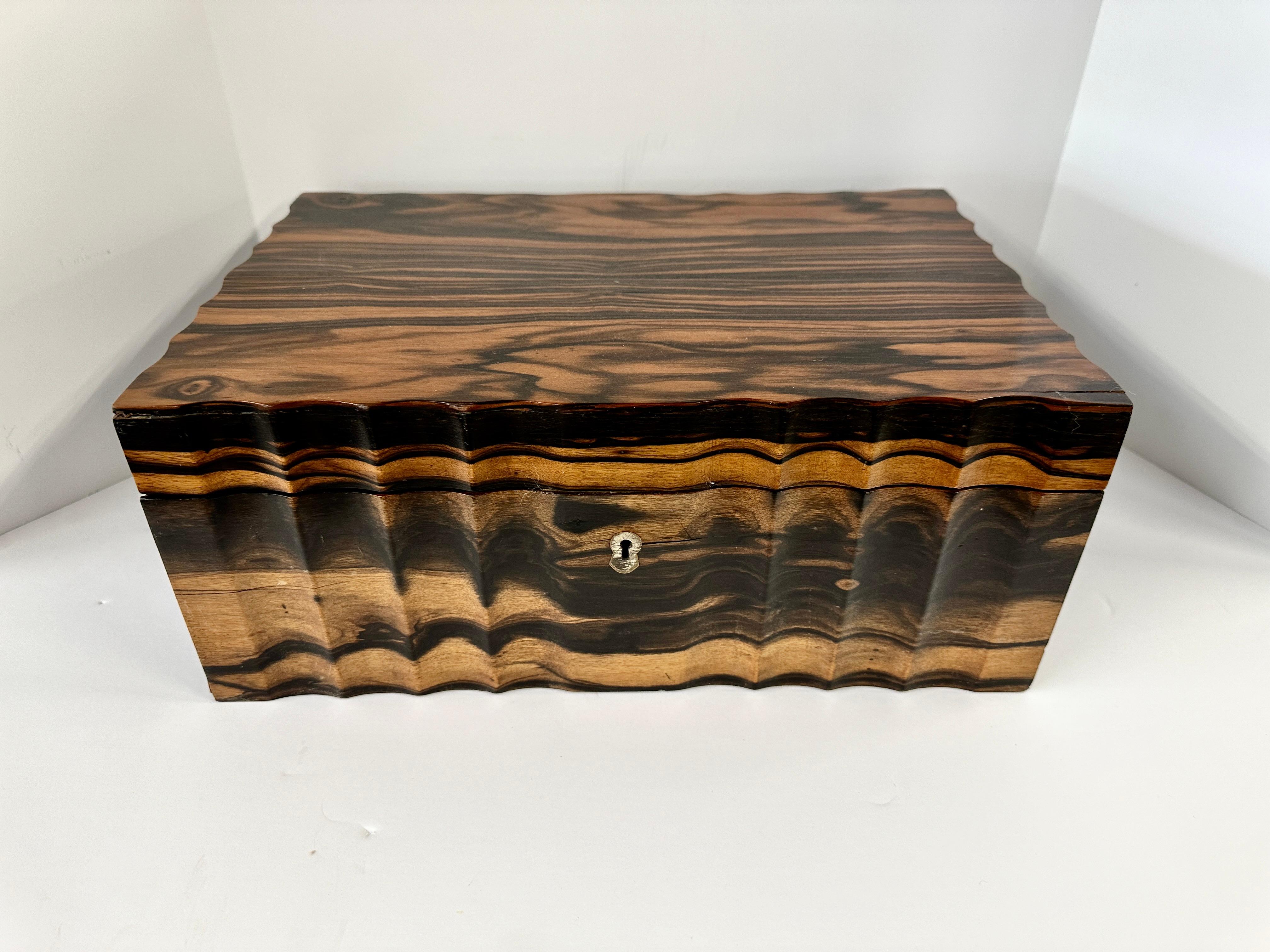 A beautifully grained and fitted Tea or Spice box in Coromandel. Likely Anglo Indian although these were also made in Ceylon I believe. Two levels and storage underneath these two levels.  The top compartment has bone inlaid top pieces with pen and