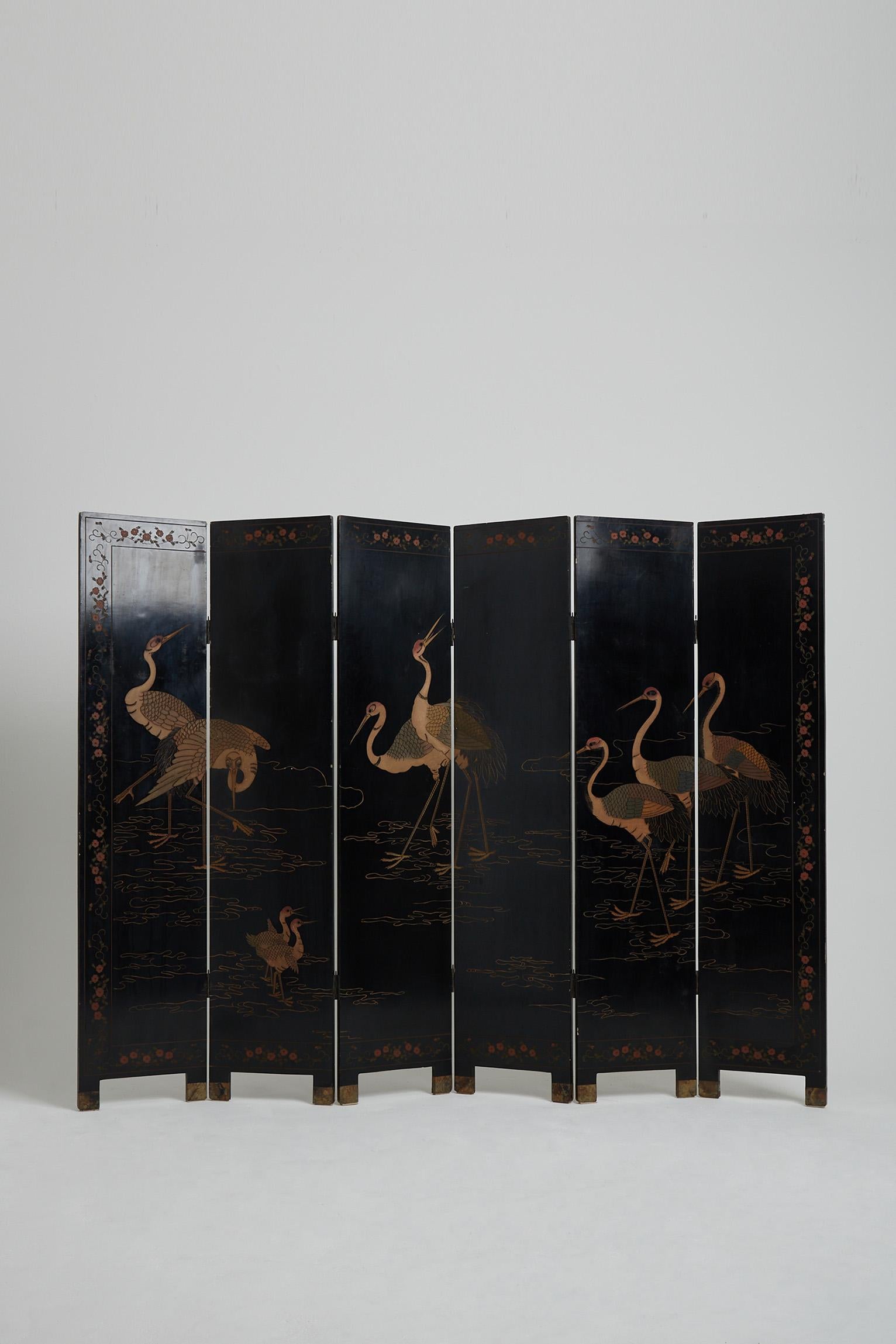 A brass mounted six-leaf and two-face coromandel lacquer screen, with birds, cranes, flowers and bamboo motifs.
China, first half of the 20th century.
