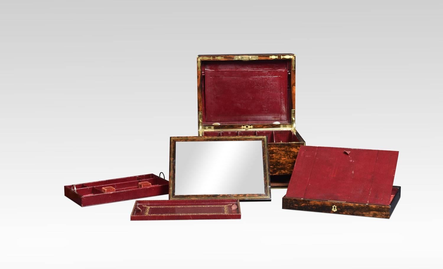 Brass bound ladies travelling dressing table box, by Halstaff & Hannaford, London. The coromandel box with working Bramah lock with key. The compartmentalized interior of the box is also of very high quality. It is lined in velvet and embossed