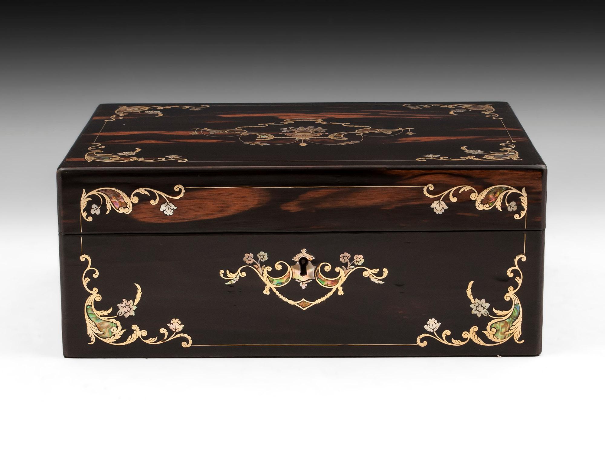 Coromandel jewelry box with intricate mother of pearl, abalone and brass wire floral inlays to the top and front. 

Opening this exquisite jewelry box lid reveals a teal padded velvet and white silk paper lined interior removable tray, featuring a