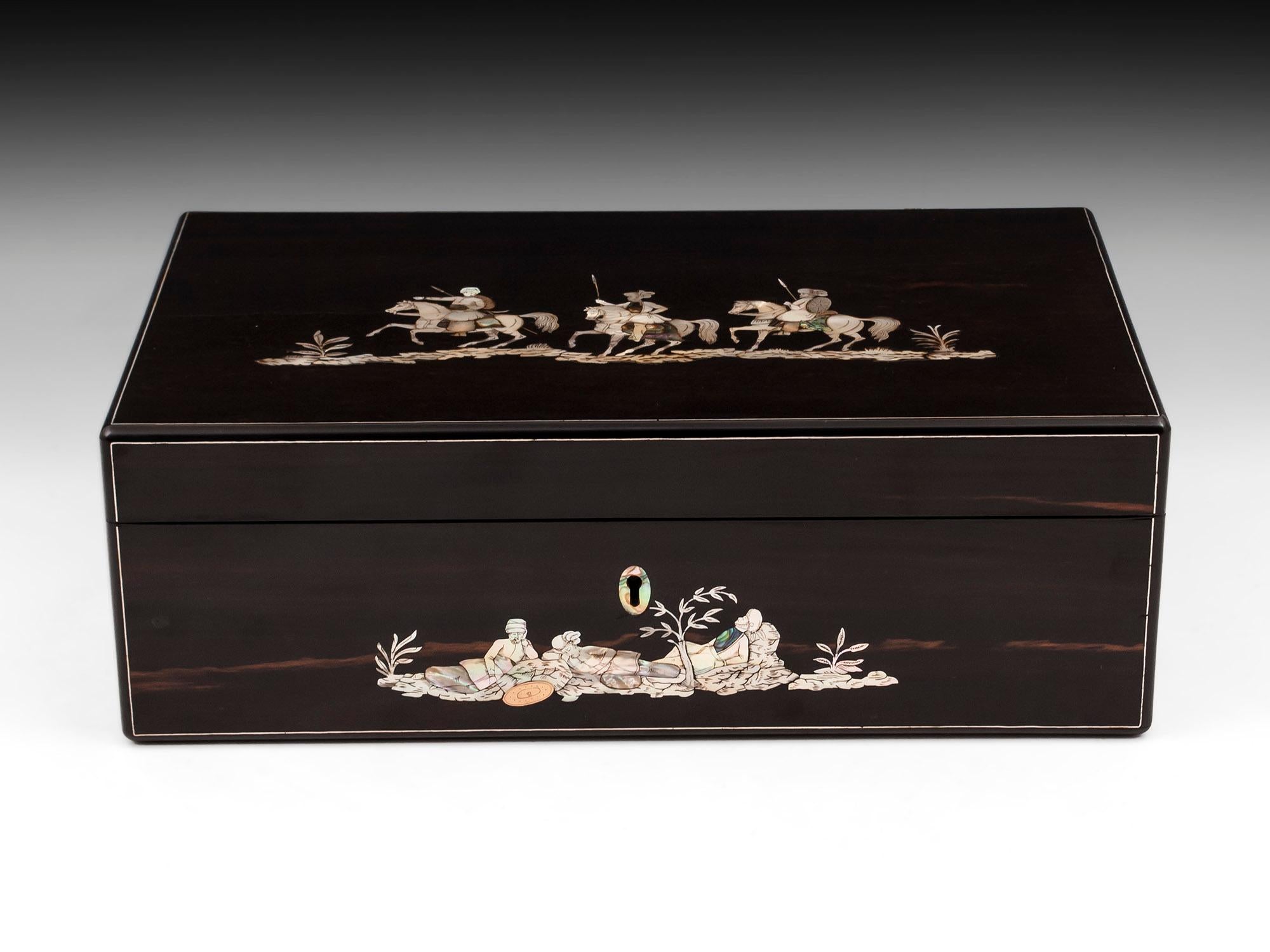 Magnificent coromandel writing slope by W.C. Fuller, London. Inlaid and engraved in mother-of-pearl, abalone and brass with three exotic warriors on horseback with shields and spears to the top, the front of the box depicting their overnight