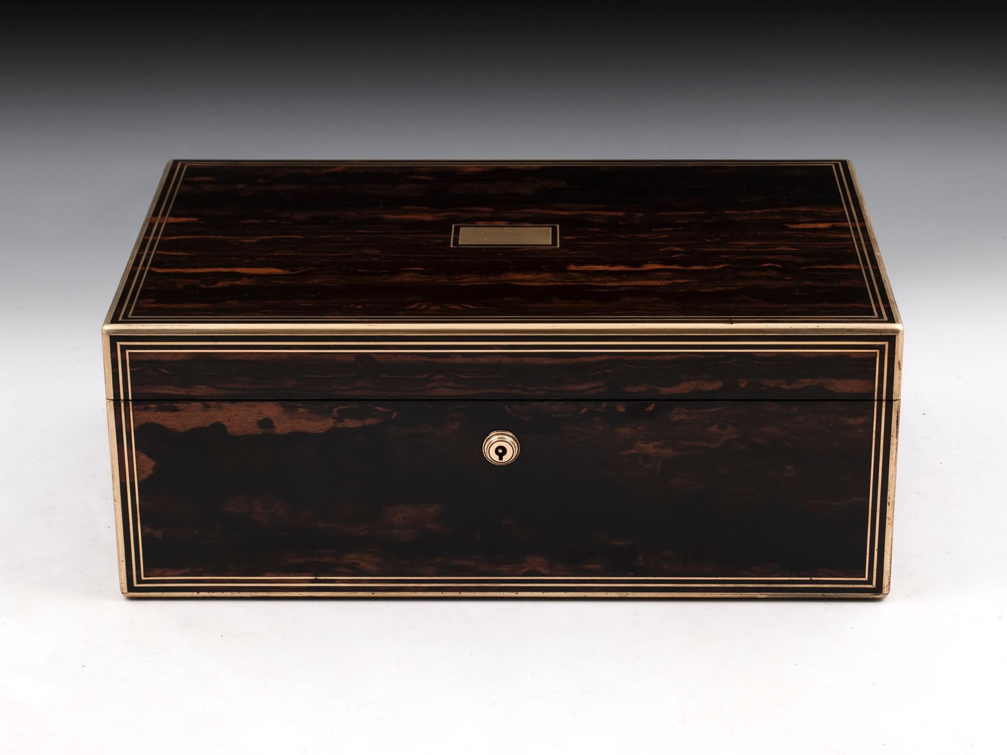 Antique coromandel and satinwood lined writing box by Lund of London, with brass edging and double stringing. With vacant initial plate and escutcheon.

The satinwood lined interior features a black gold tooled leather writing surface which has
