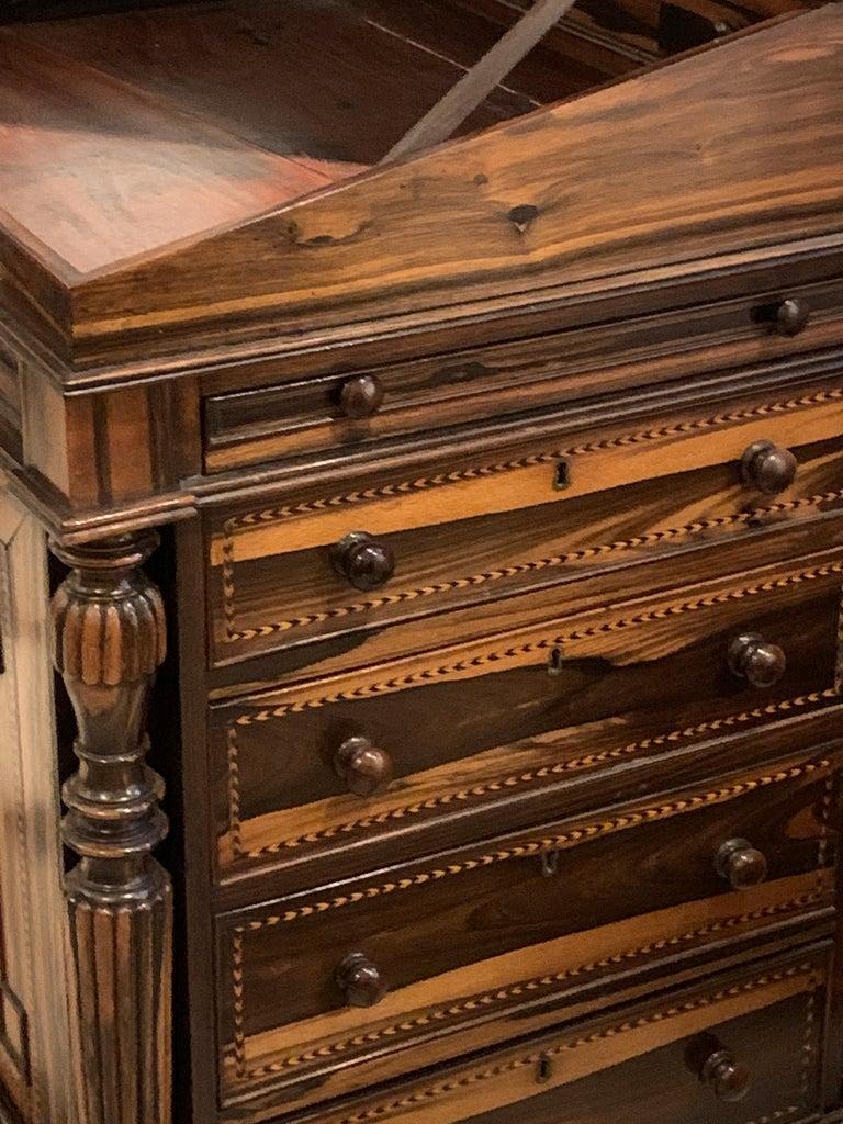 Coromandel wood davenport desk. William IV, in the style of Waring and Gillows, with sliding desk top and drawers.
This very rare davenport desk has an unusual design with extremely fine and intricate attention to detail,
circa 1840.